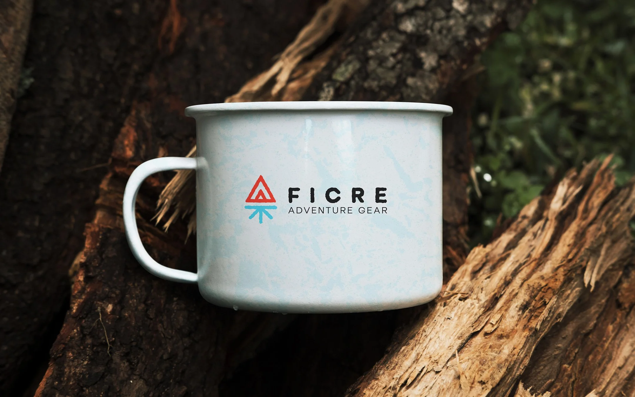 FICRE logo on a white enamel mug, perched on a tree branch
