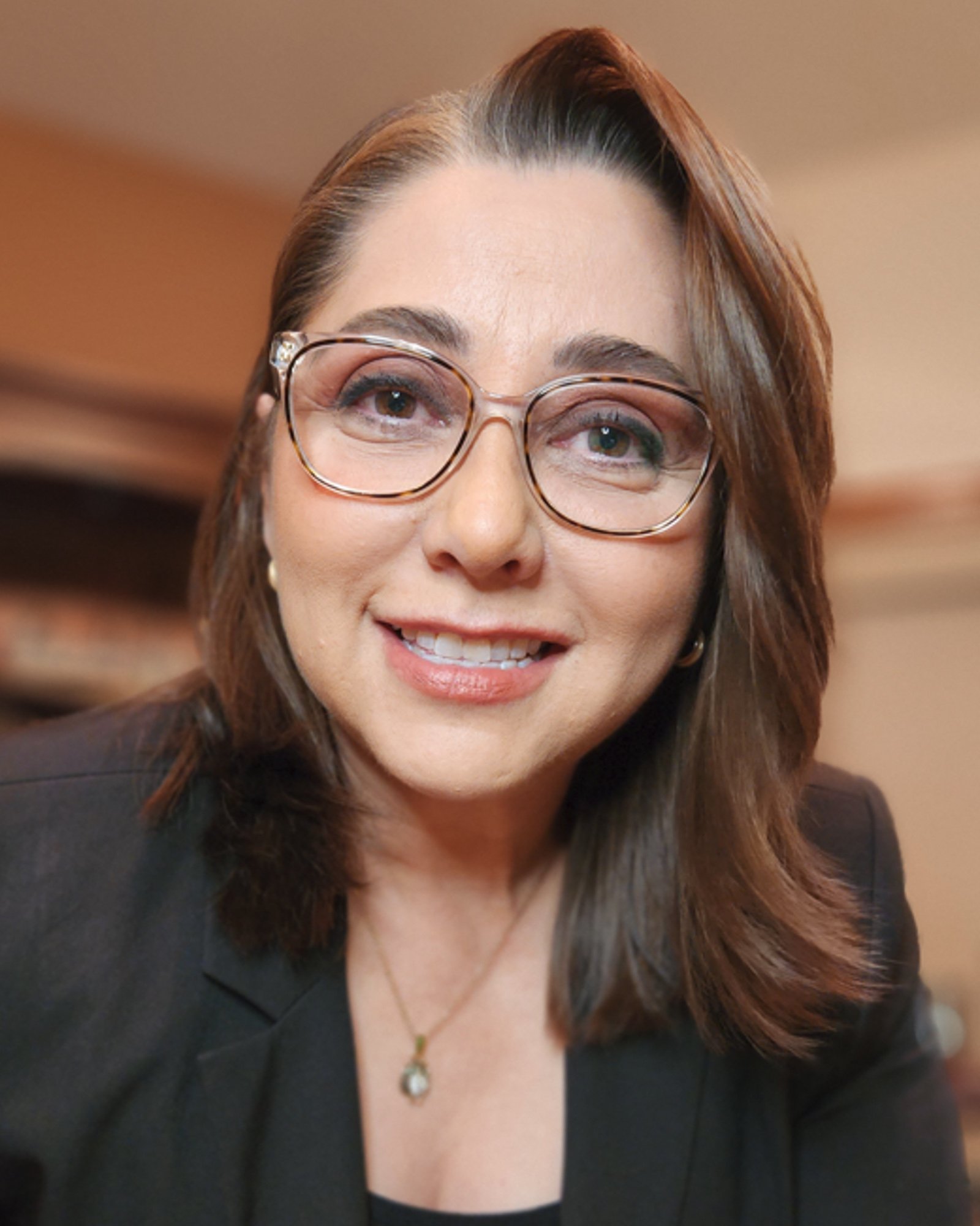 A portrait of Nora Díaz, one of the co-host of the AI in translation summit. The AI in Translation Summit is a FREE virtual event for translators diving deep into the industry-specific aspects of AI so you can stay relevant, and thrive