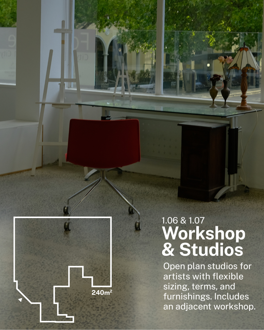 Interior view of an art studio with a red chair, a glass-topped table, and decorative vases with a lamp on a windowsill; outside trees are visible through the window. Text overlay describing an open plan art workshop and studio space.