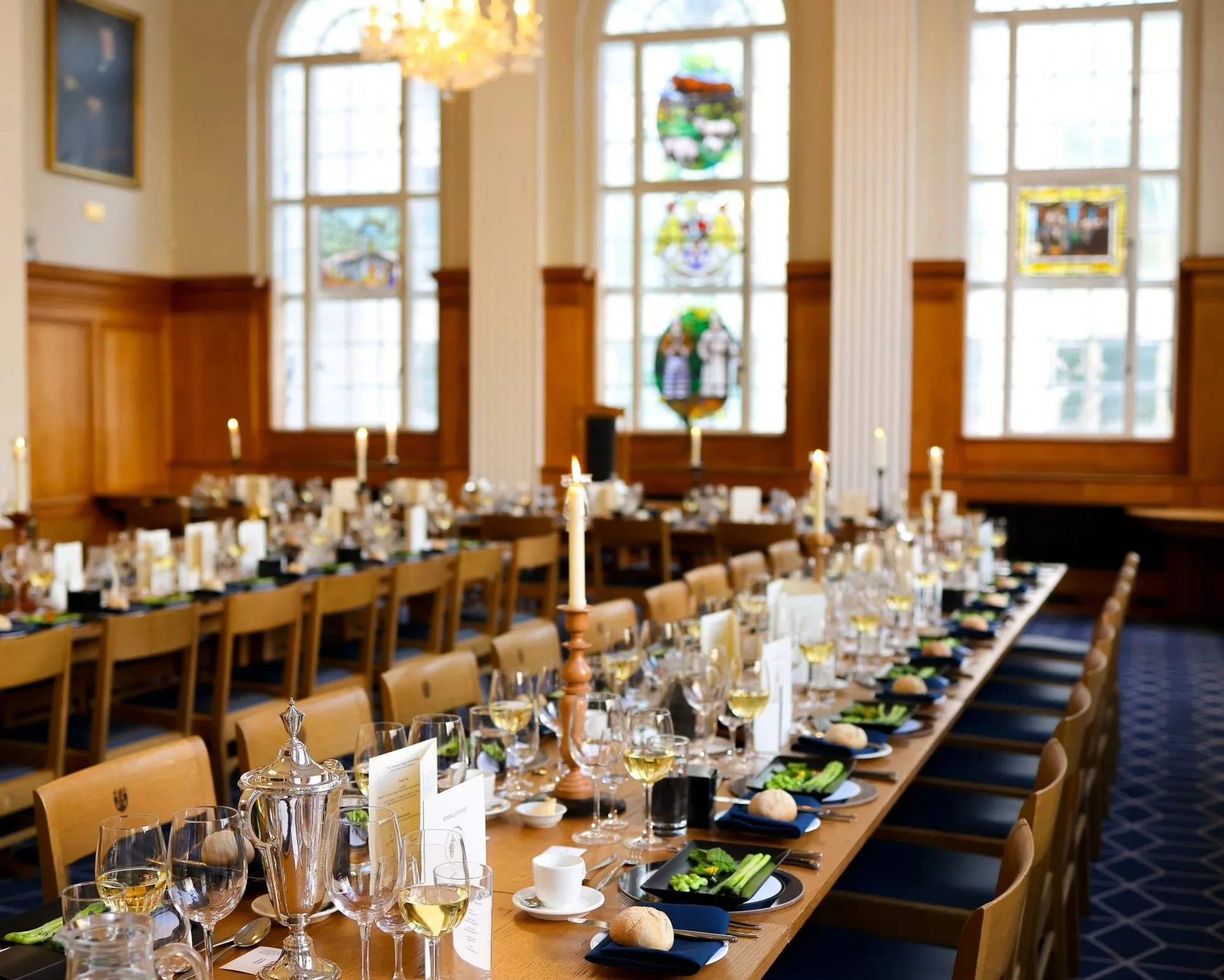 Long-table dining setup at the great hall showcasing beautifully styled place settings, candlelight and a refined atmosphere for corporate dinners, celebrations and private events.