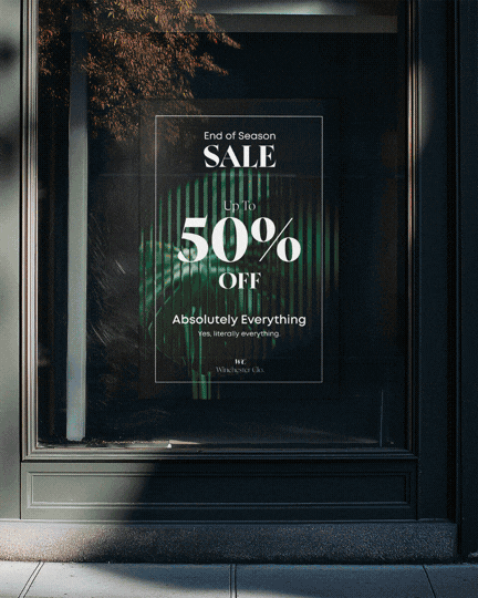 A store window displaying a sale sign with up to 50% off, advertising end of season sale and everything discount.