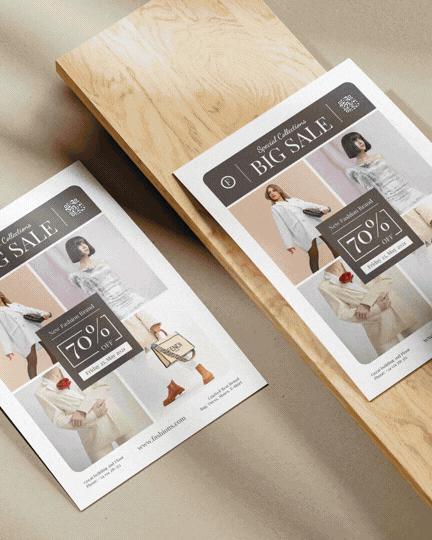 Flyer advertisements for a big sale with images of women modeling clothing, offering up to 70% off, placed on a wooden table.