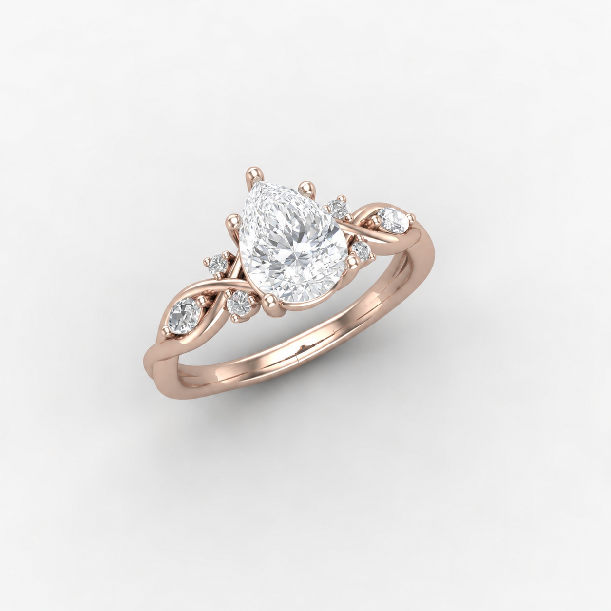 A rose gold engagement ring with a large pear-shaped diamond centerpiece and smaller diamonds on a delicate band.