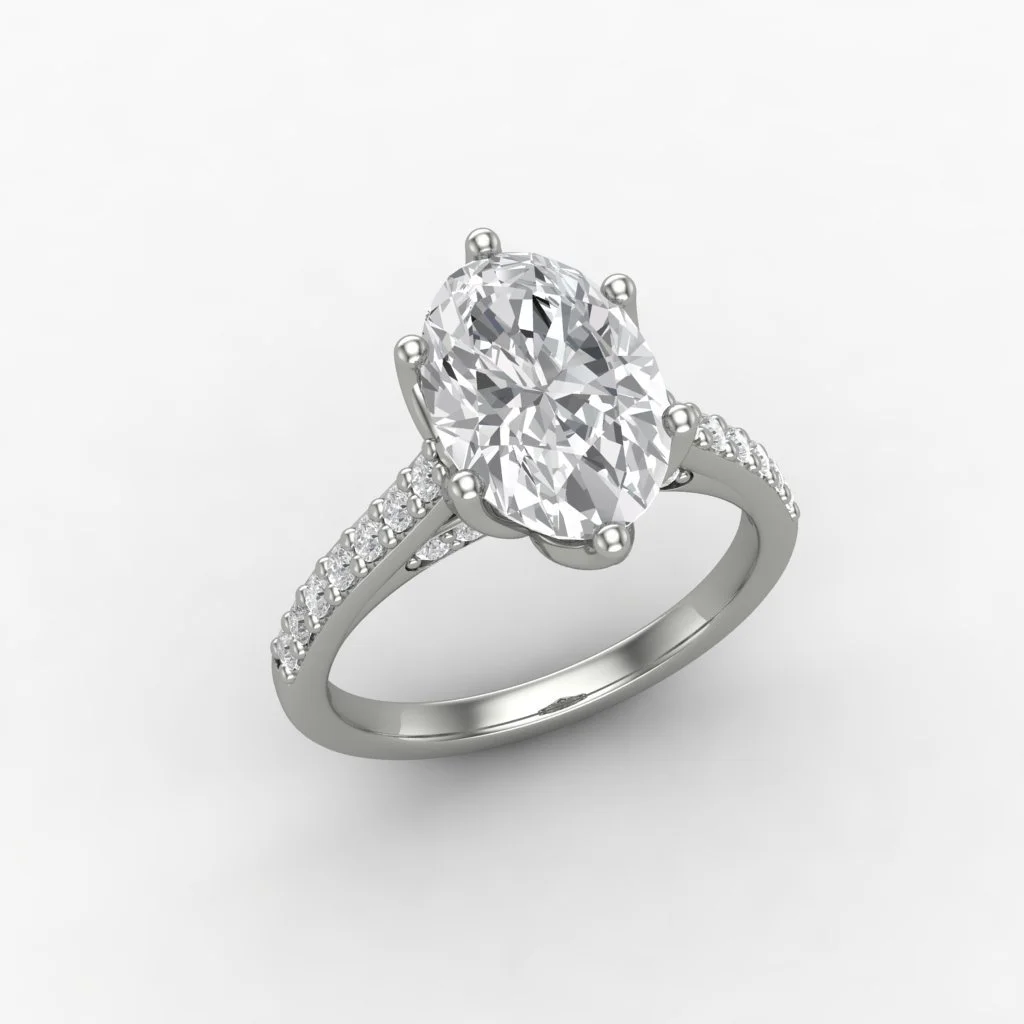 A silver ring with a large oval-shaped diamond in the center, surrounded by smaller diamonds on the band, set against a white background.