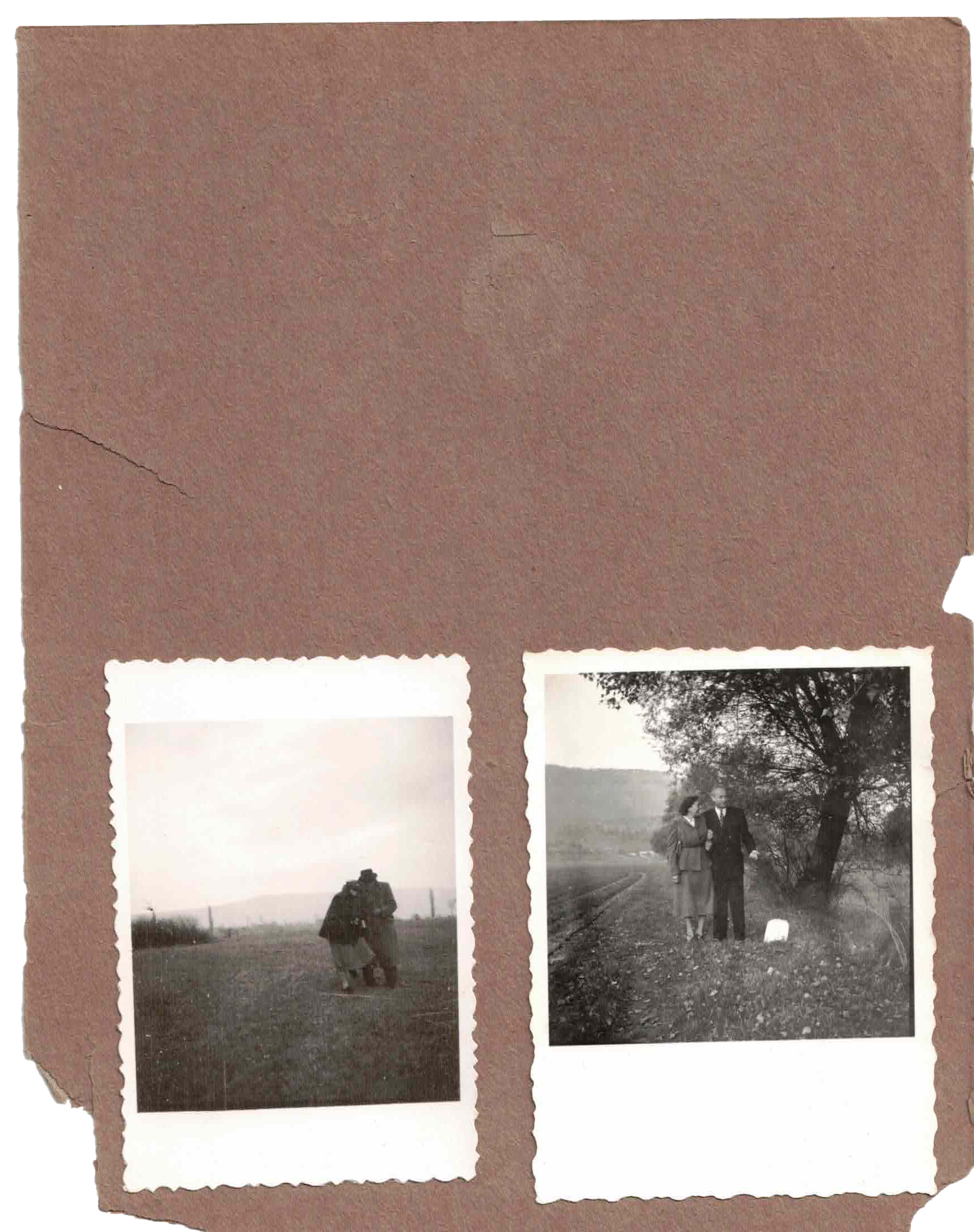 Two black-and-white photographs on a torn page of a scrapbook or photo album. The left photo shows a person wearing a coat and holding something, standing on a field with a person in the background. The right photo depicts two people walking on a dirt road beside a tree, engaged in conversation.