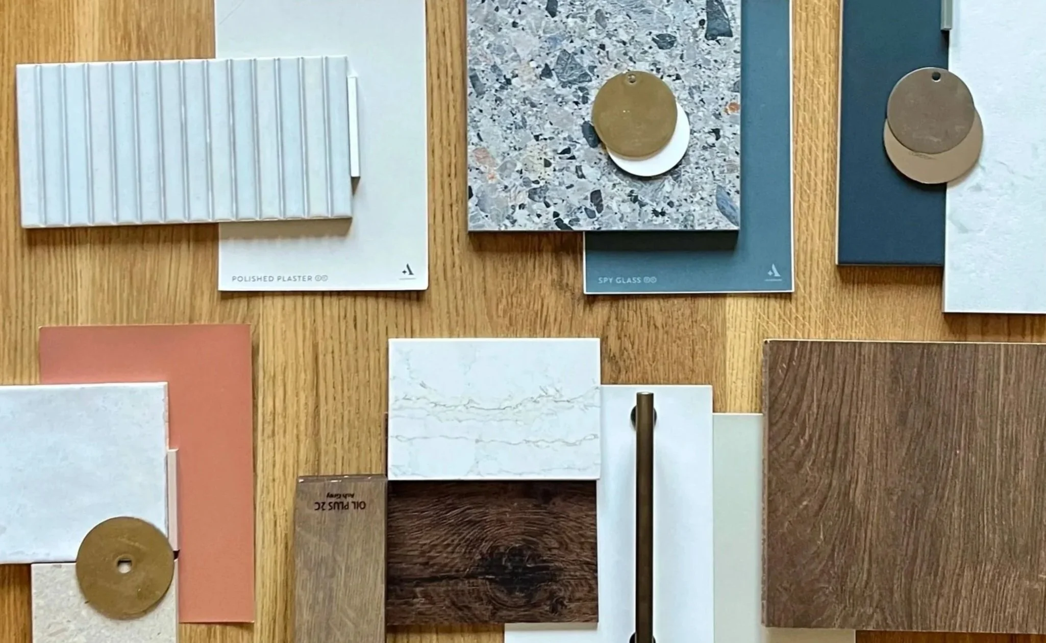 Finish board for a client project with tile, paint and wood-grain samples in a tonal palette, arranged on wood timber.