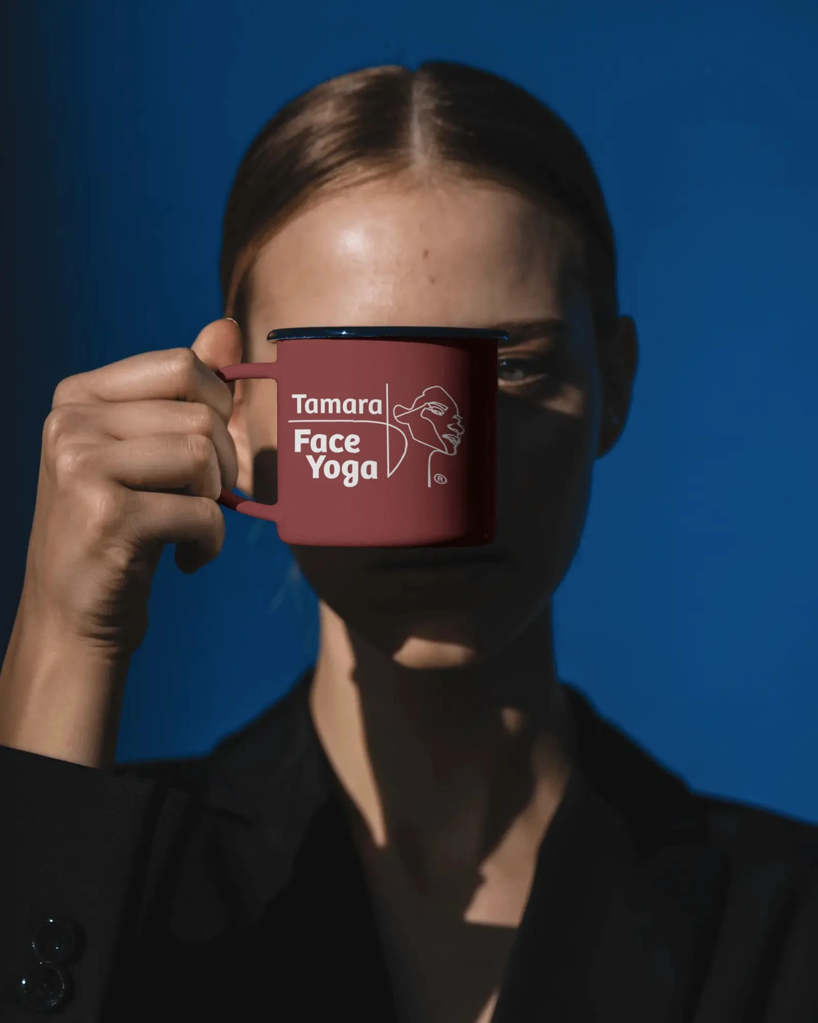 sunlit-fashion-portrait-mug-mockup-held-forward-in-clean-blue-backdrop-0422.jpg