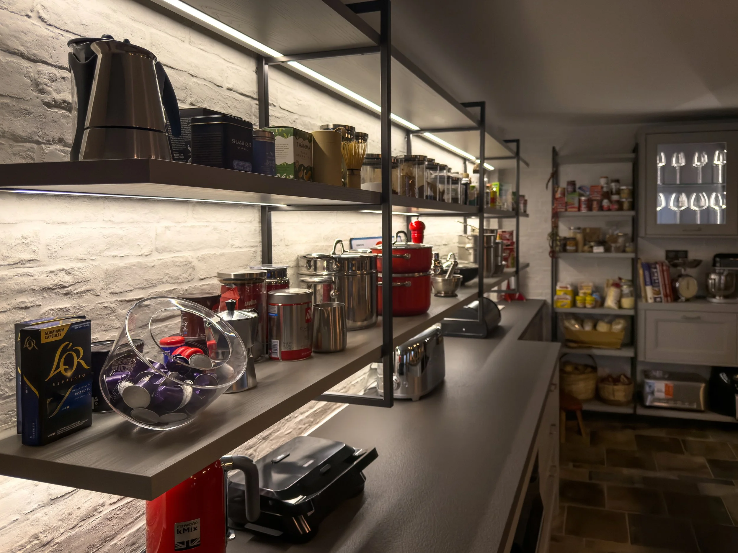 Open kitchen shelving with curated culinary details and refined everyday living at Astraea Villa