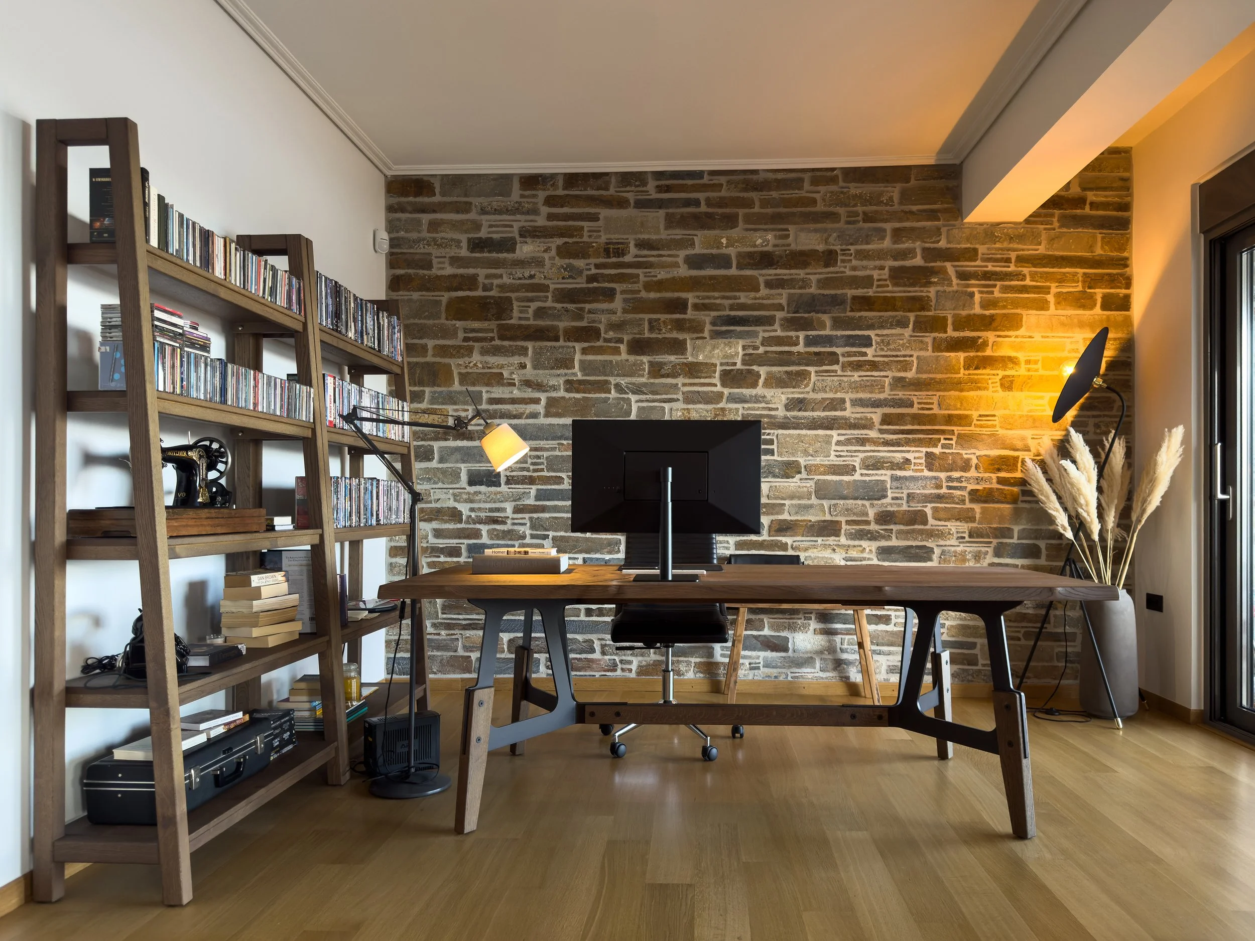 Modern home office with layered materials, curated collections and warm contemporary character at Astraea Villa.