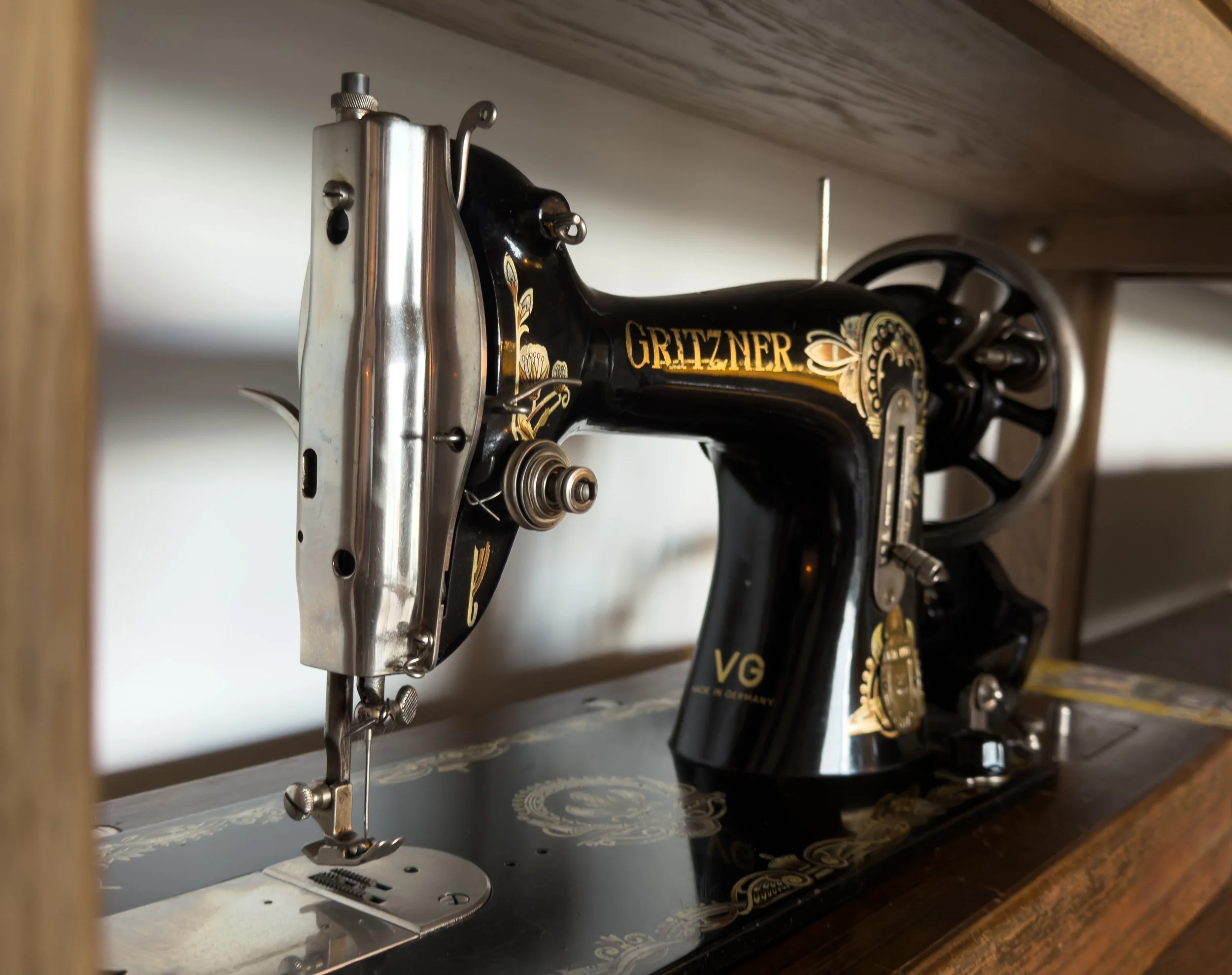Thoughtfully preserved vintage Gritzner sewing machine with timeless interior character at Astraea Villa.