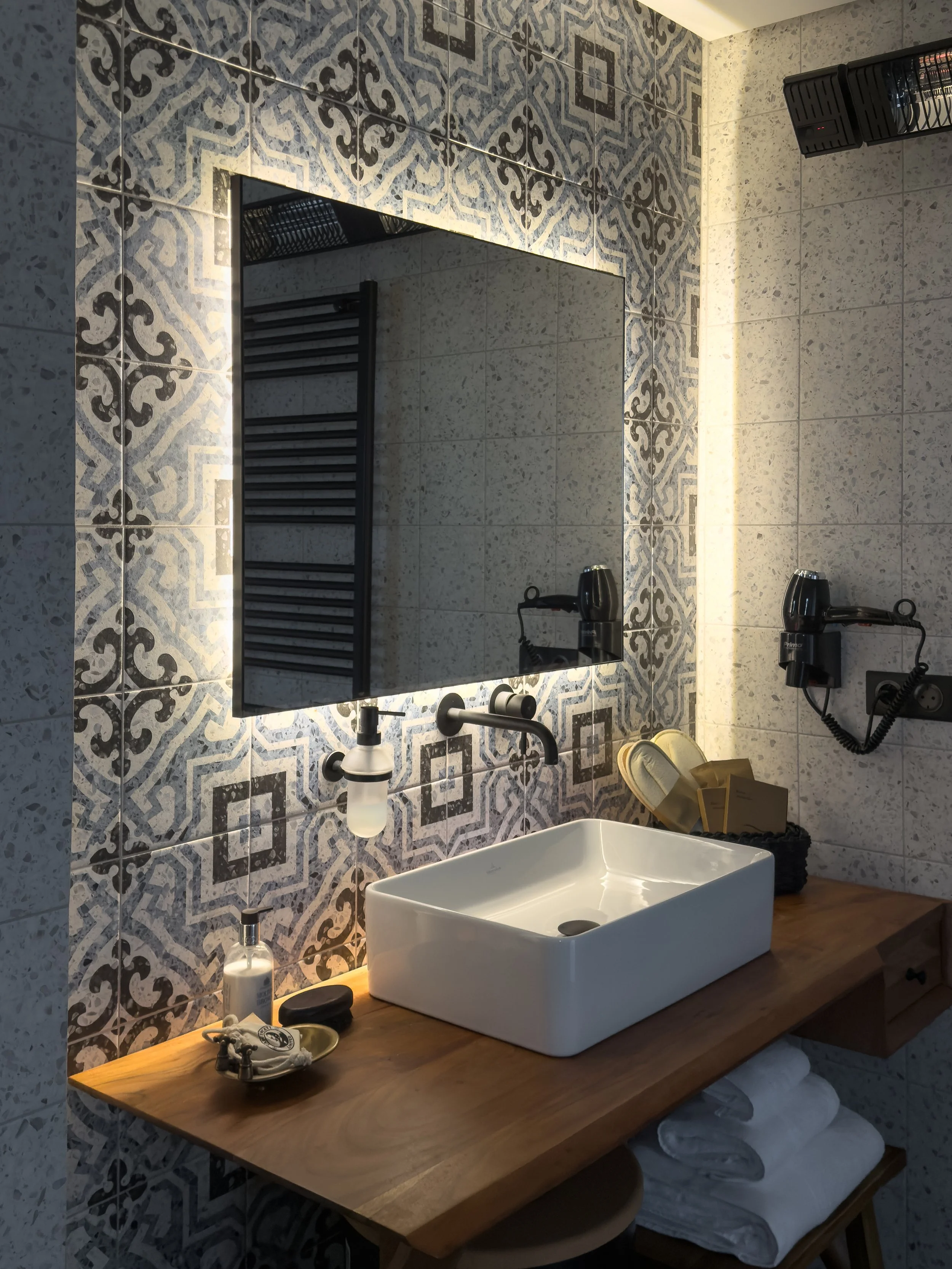 Bathroom interiors enriched by artisanal textures and tactile natural materials at Astraea Villa.