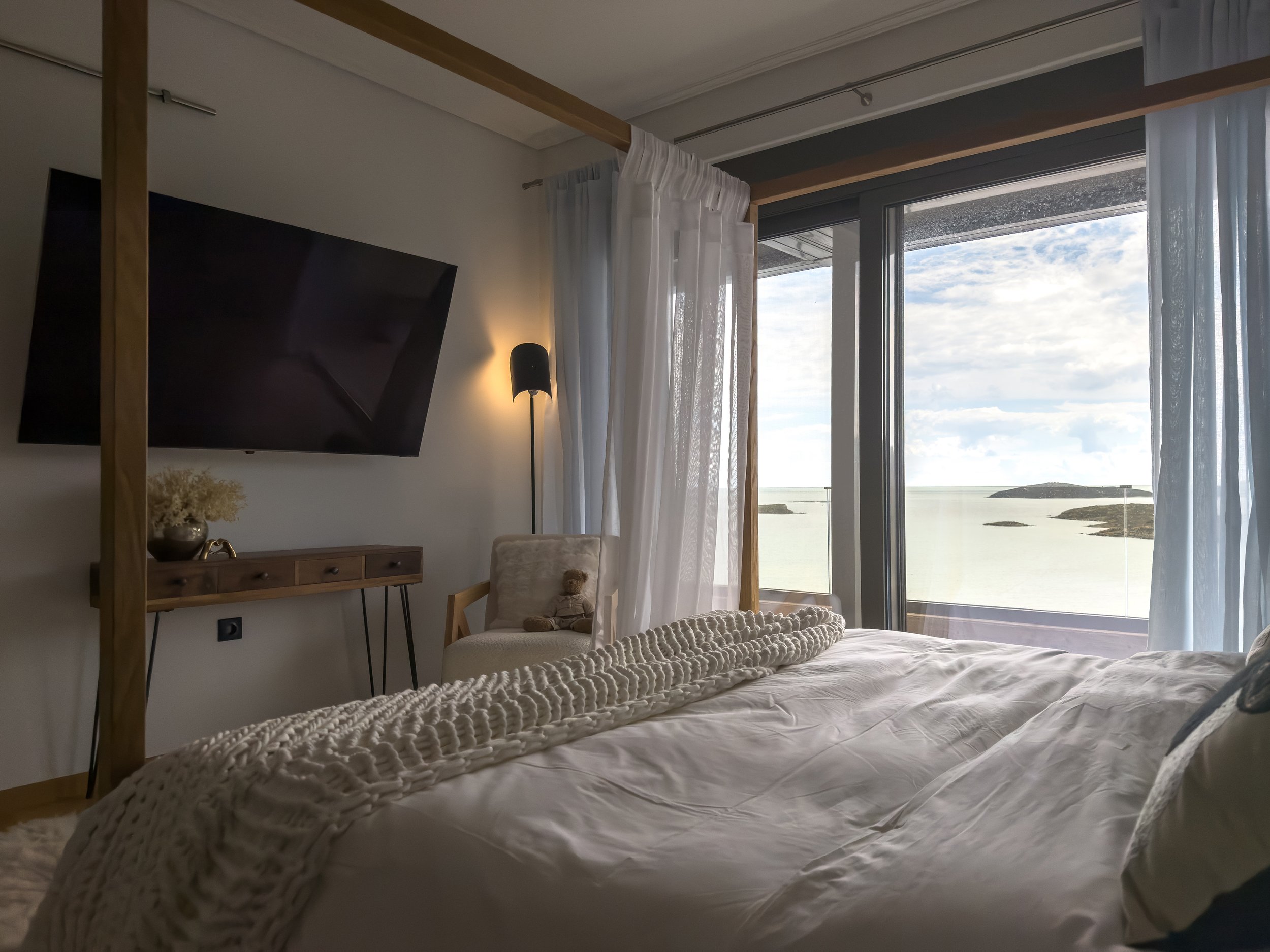 Bedroom spaces shaped by softness, light and the rhythm of coastal living at Astraea Villa.