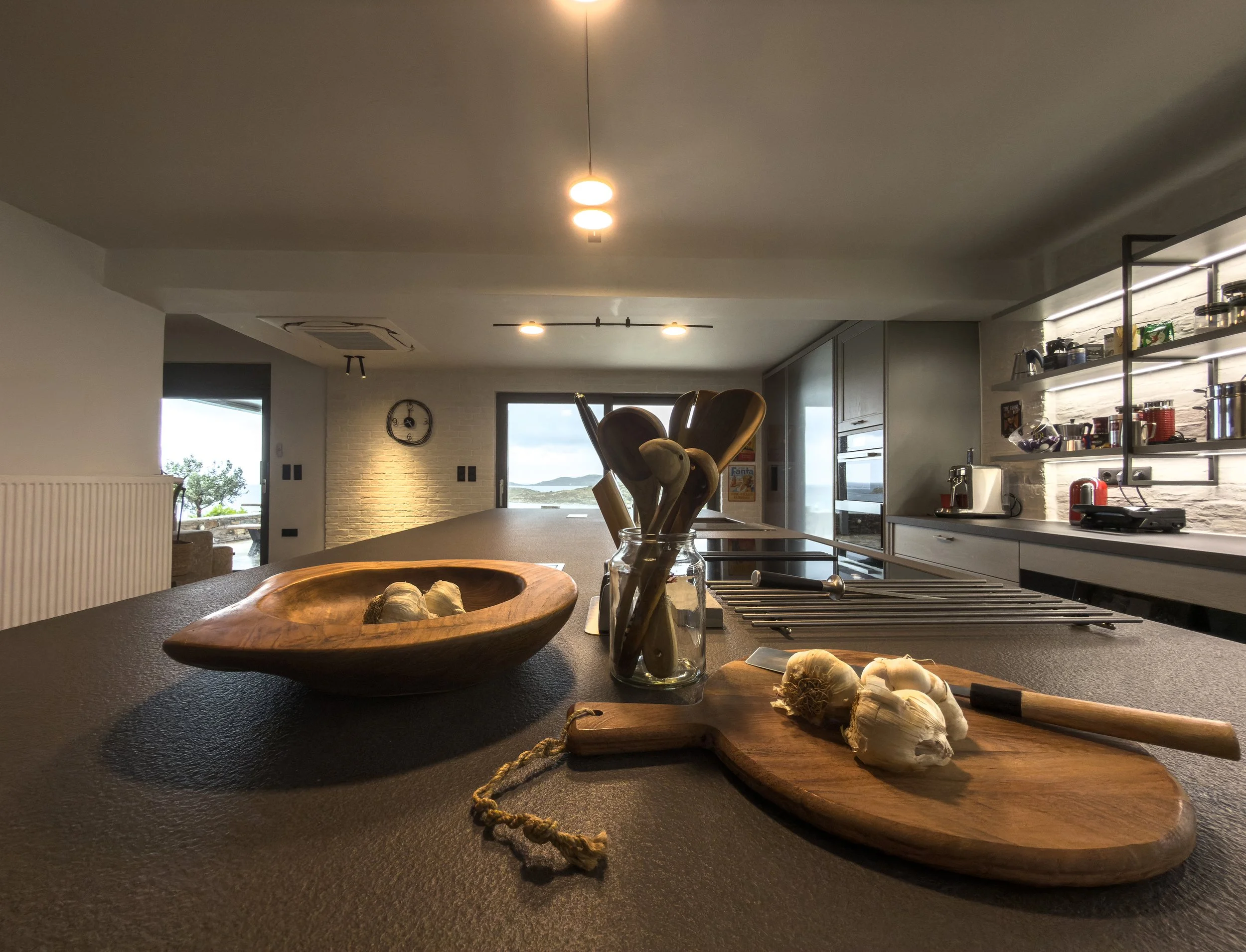 Open kitchen interiors with natural light and surrounding landscape views at Astraea Villa.