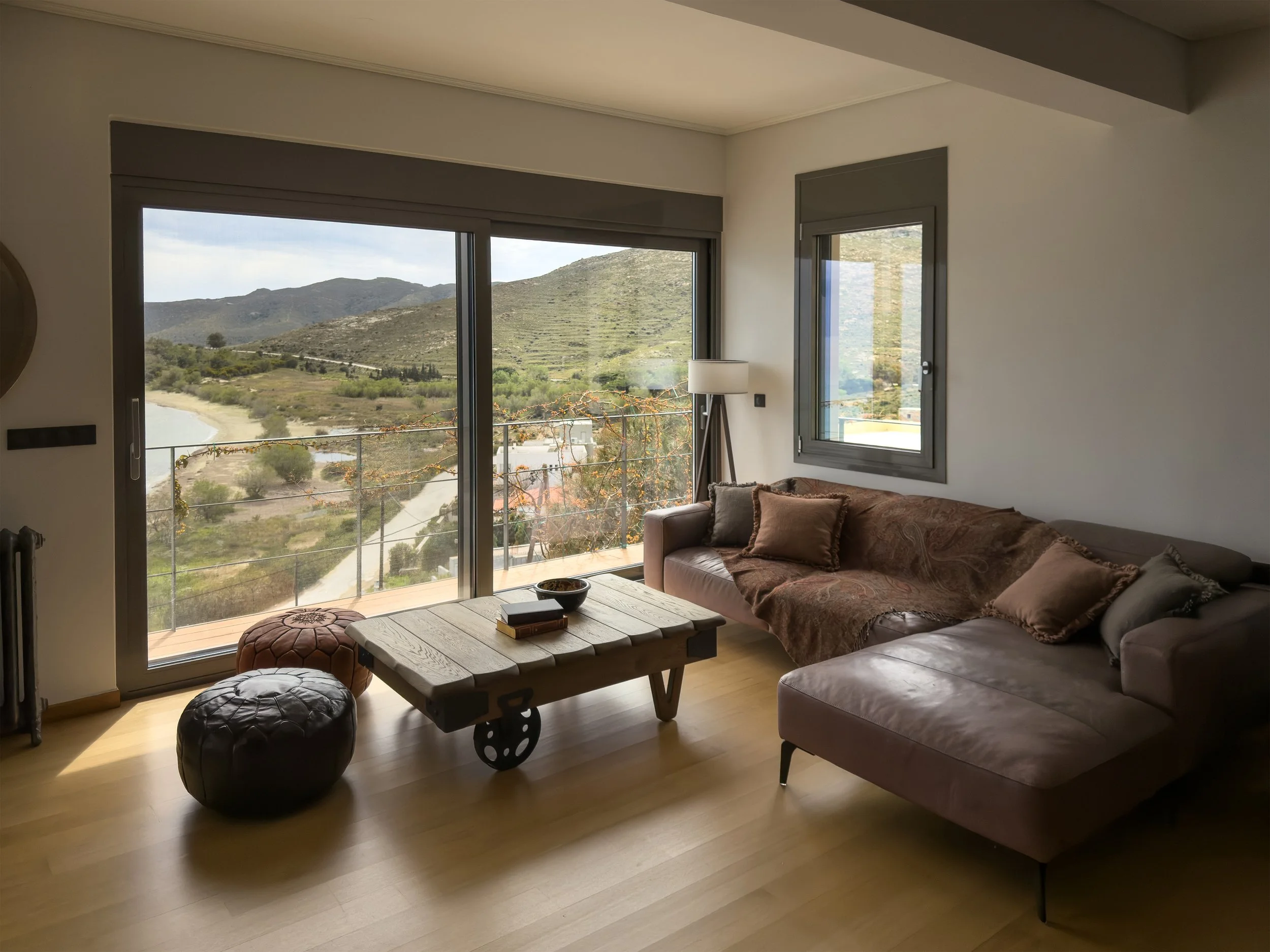 Thoughtfully composed living space with panoramic mountain and sea views at Astraea Villa