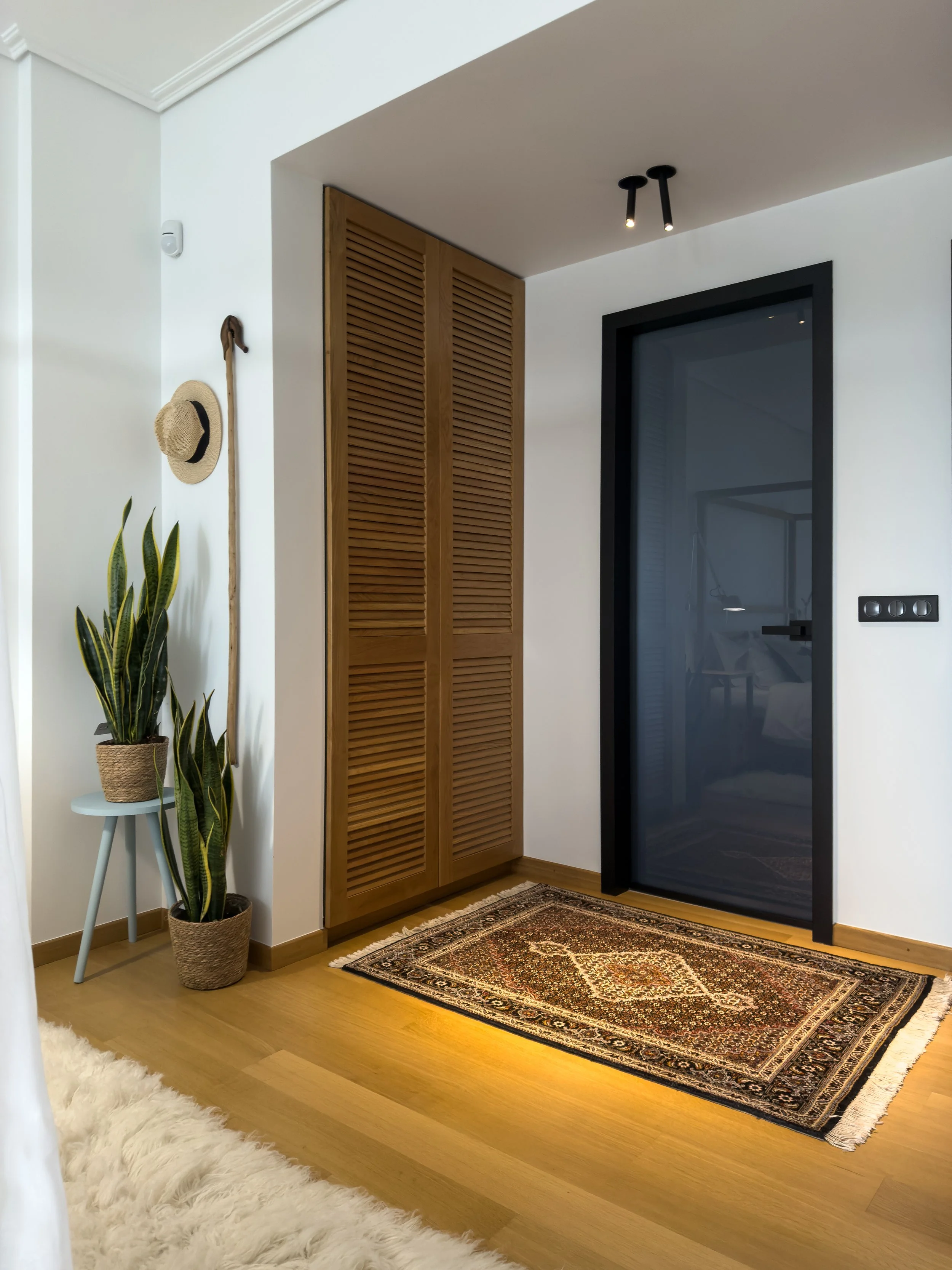 Warm interior space blending layered textures, natural materials and quiet contemporary living at Astraea Villa.