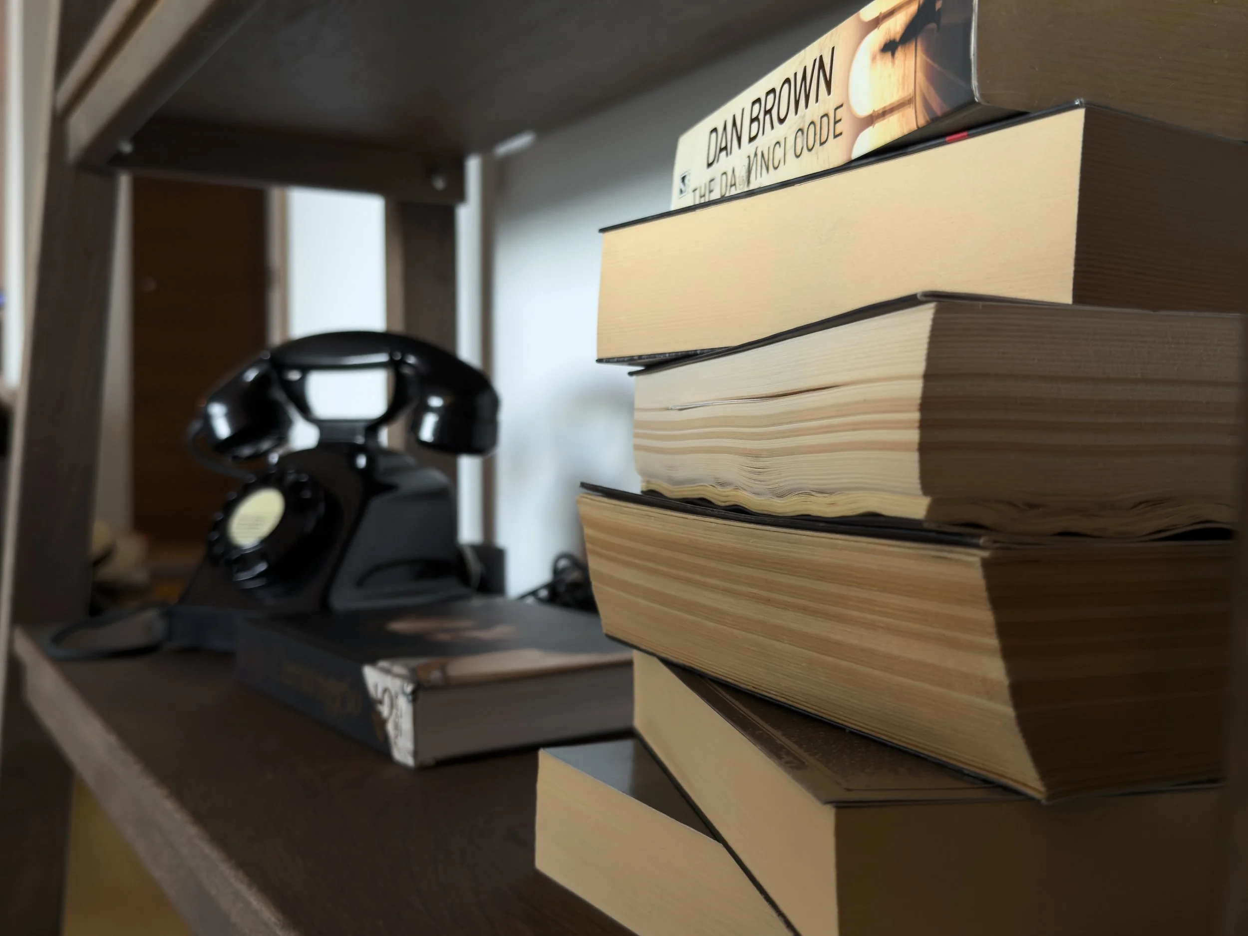 Vintage rotary phone and curated books adding nostalgic character to the interiors of Astraea Villa.