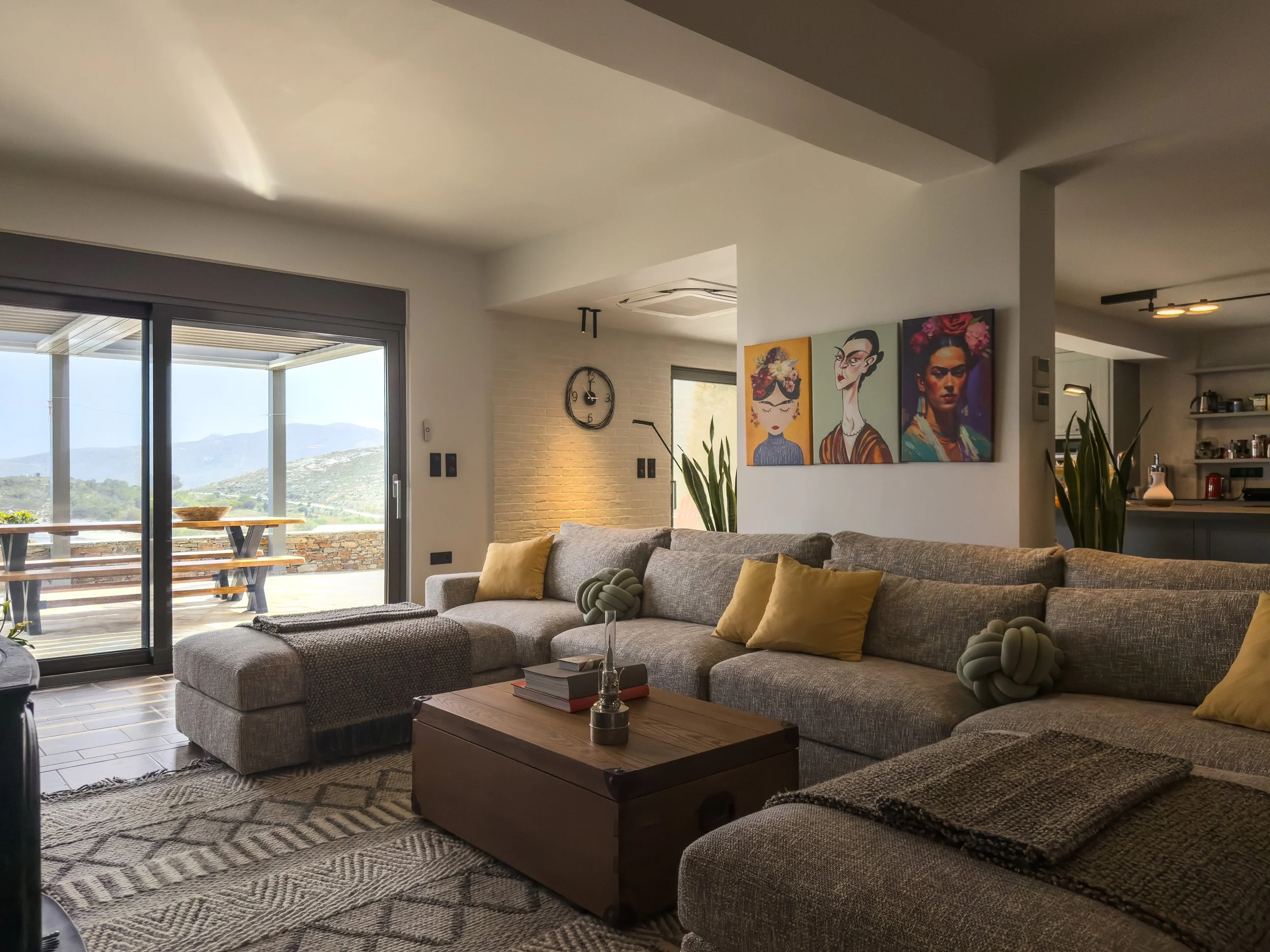 Thoughtfully designed living space with curated artwork and open mountain views at Astraea Villa.