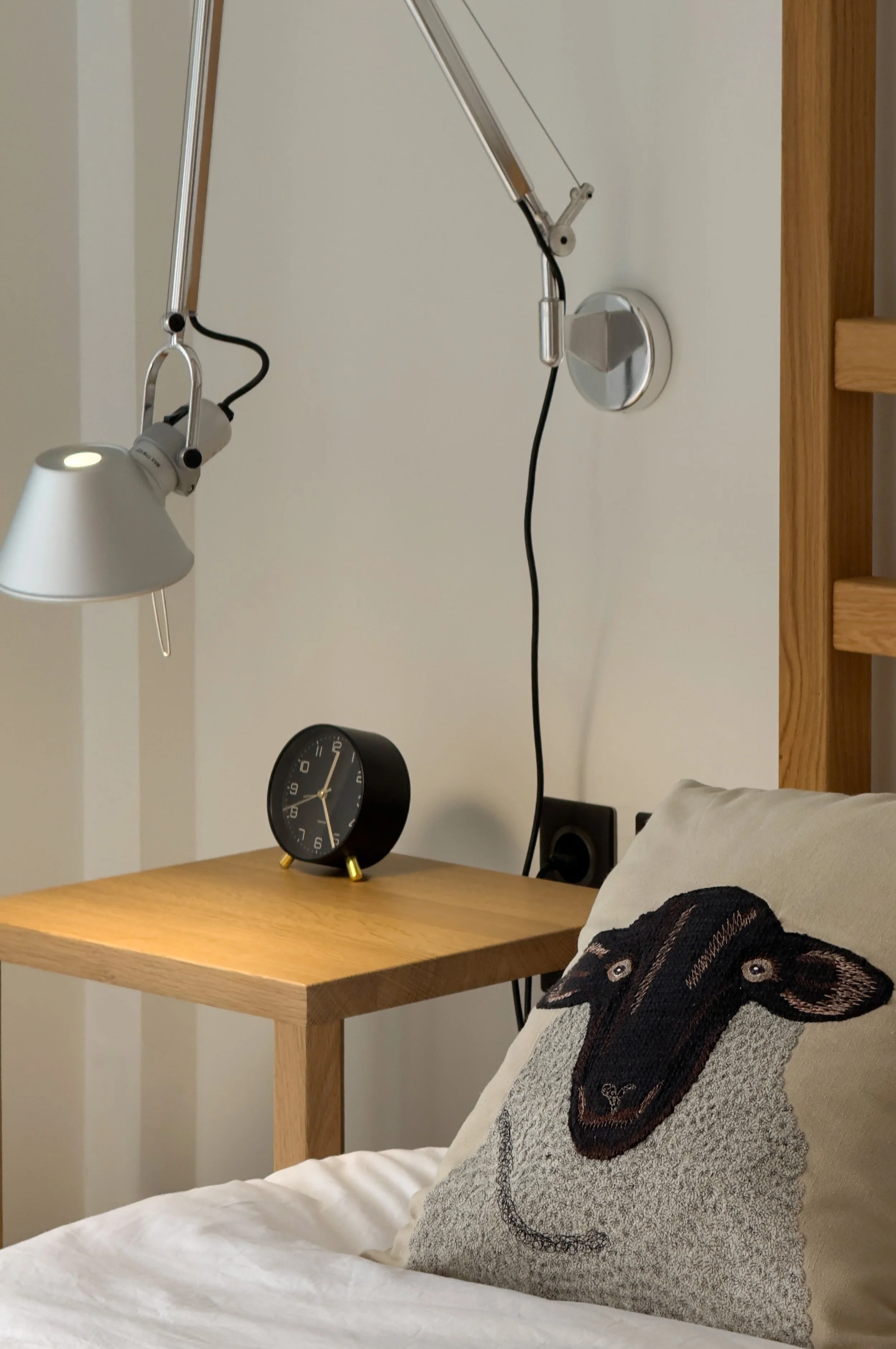 Warm bedroom interiors blending natural materials, layered comfort and quiet contemporary living at Astraea Villa.