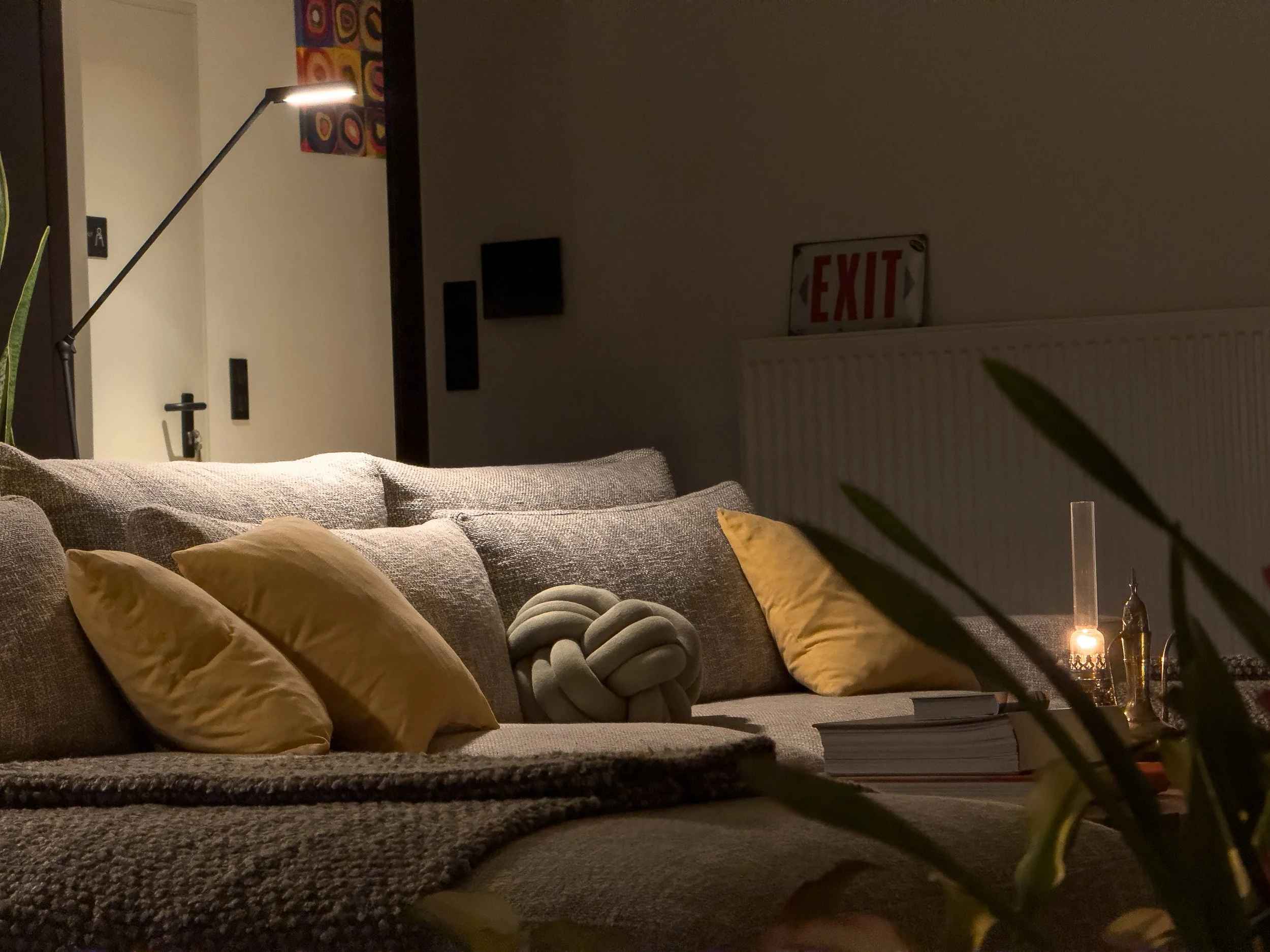 Cozy living area blending soft textiles, candlelight and quiet contemporary atmosphere at Astraea Villa.