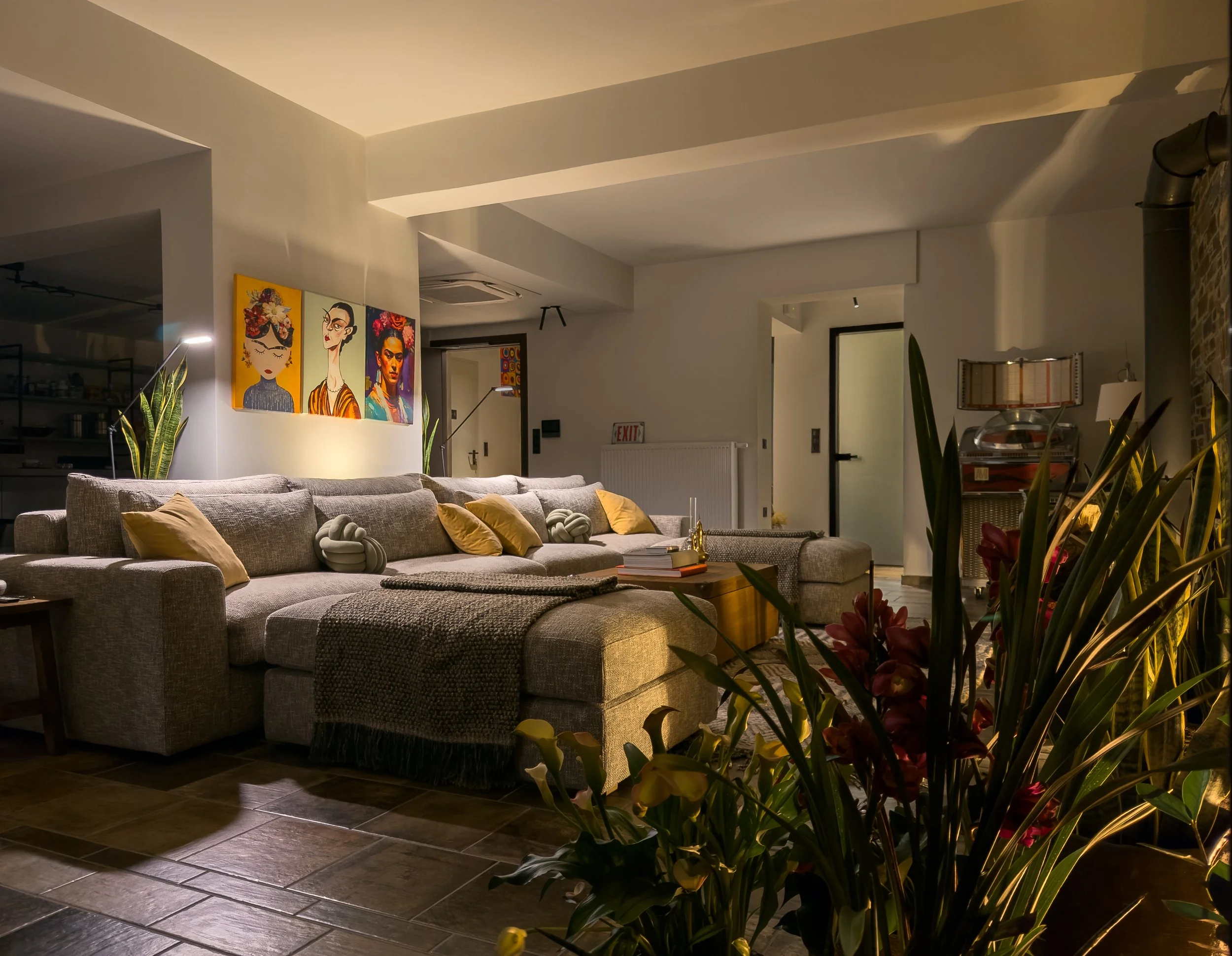Layered living interiors with exposed brick textures, curated décor and refined contemporary atmosphere at Astraea Villa.