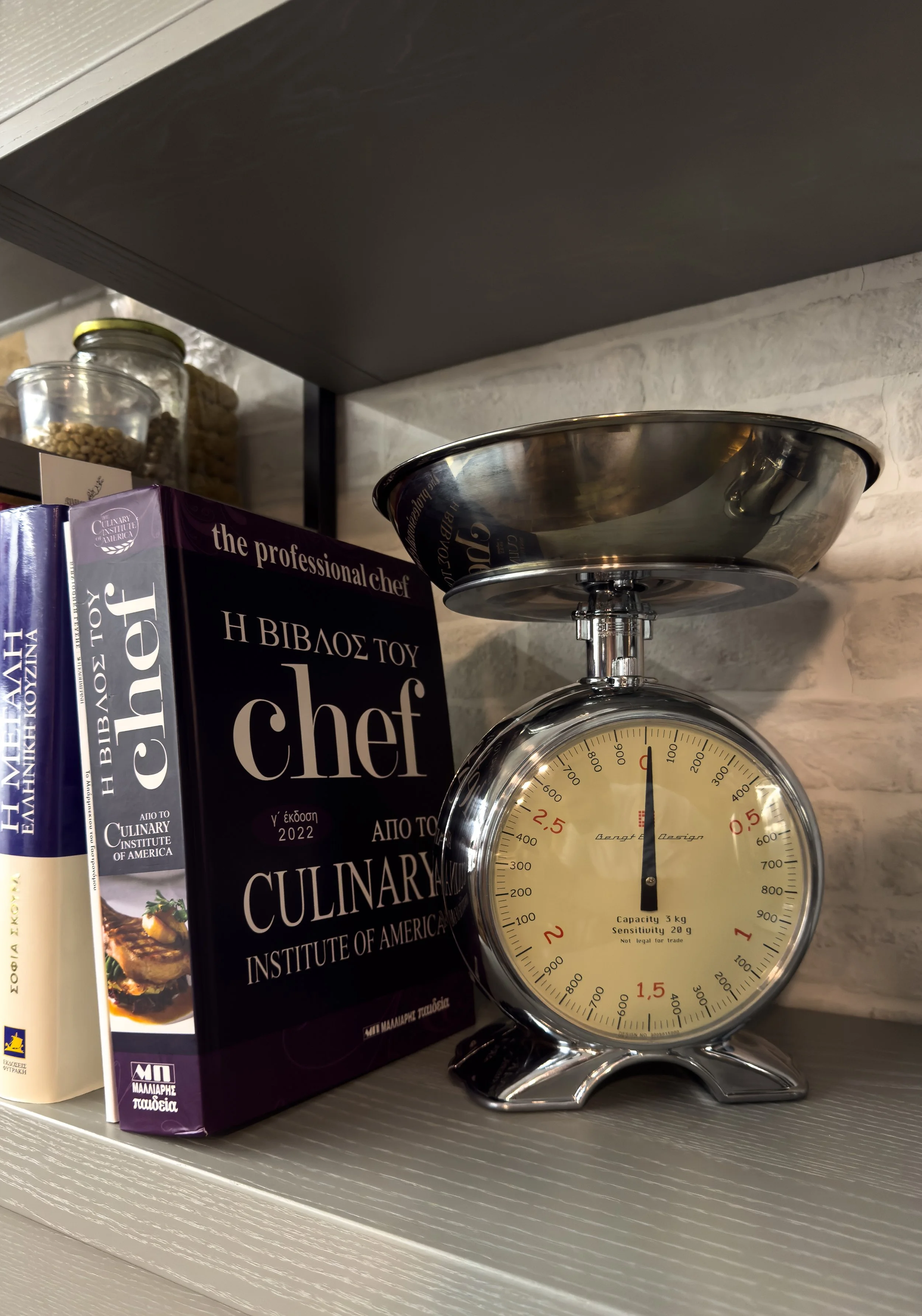 Curated culinary details with tactile materials and refined kitchen character at Astraea Villa.