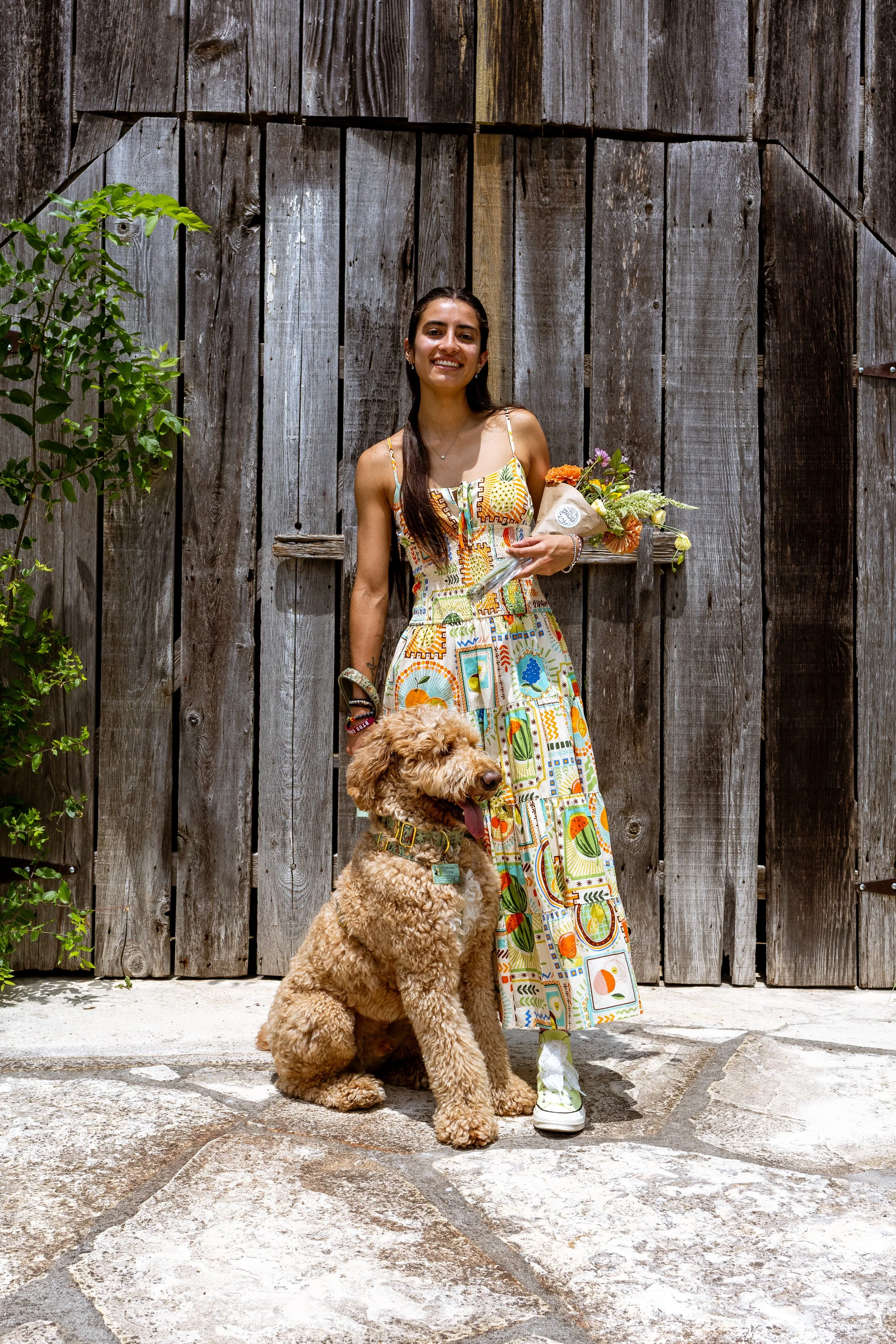 Shopper with bouquet of flowers and dog