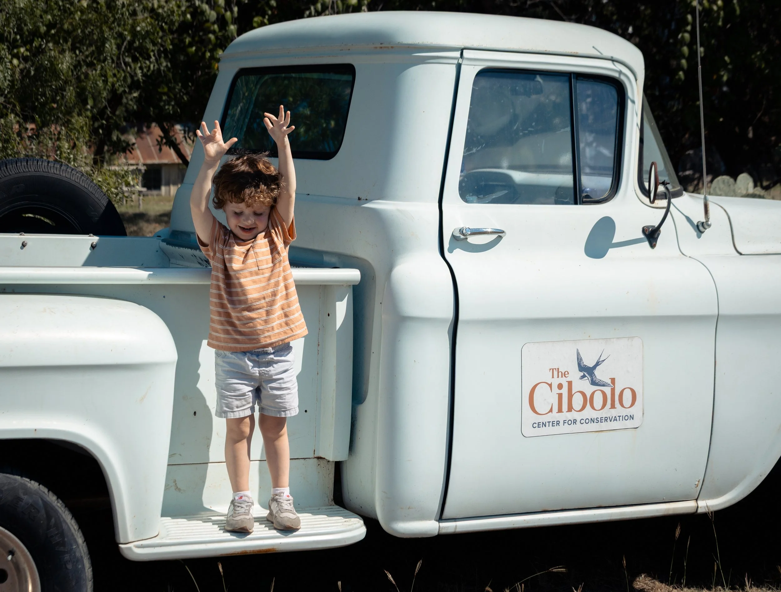 Kid jumping from vintage farm truck