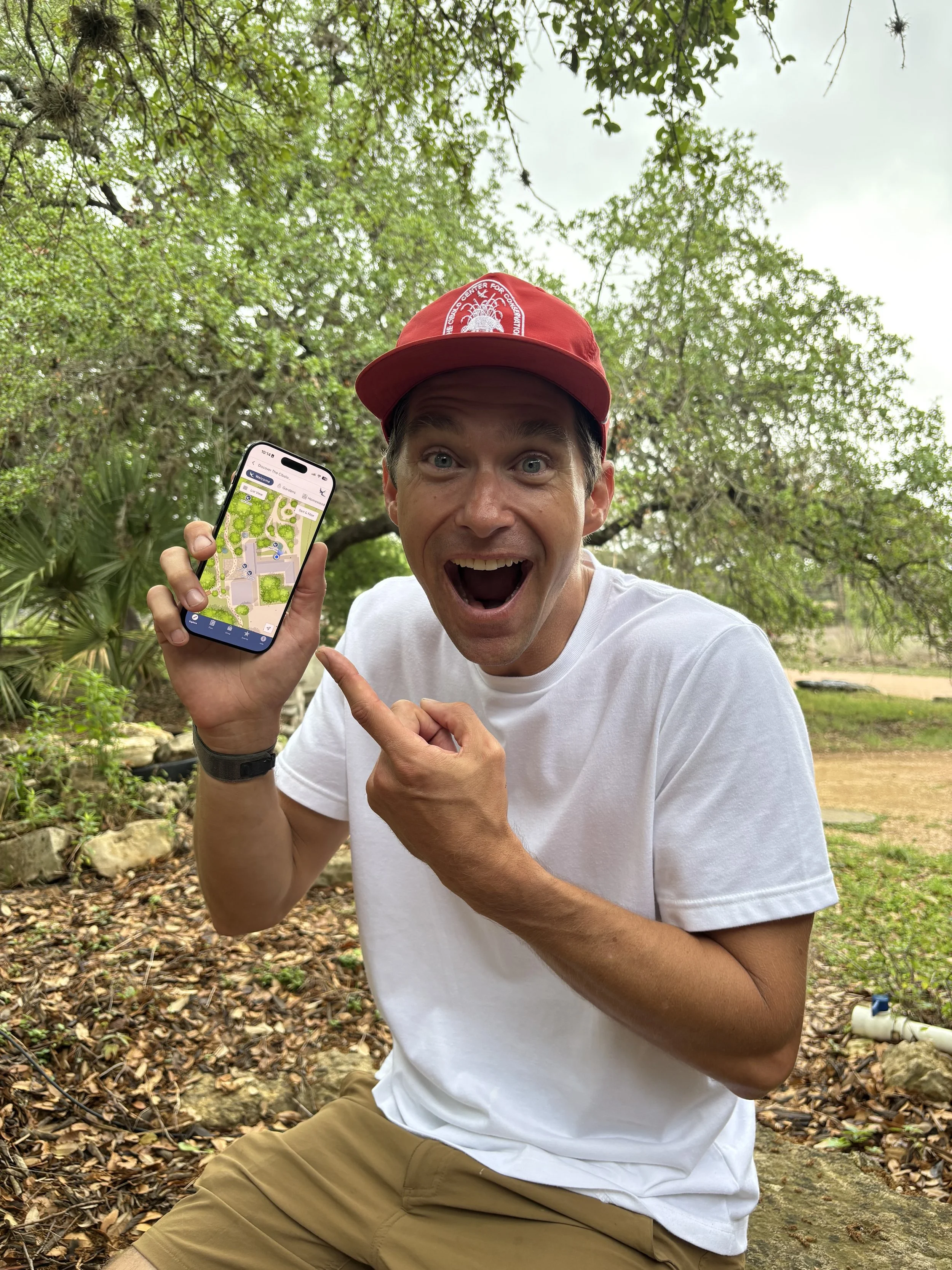 Man excited about The Cibolo's mobile app and pointing to it on his phone