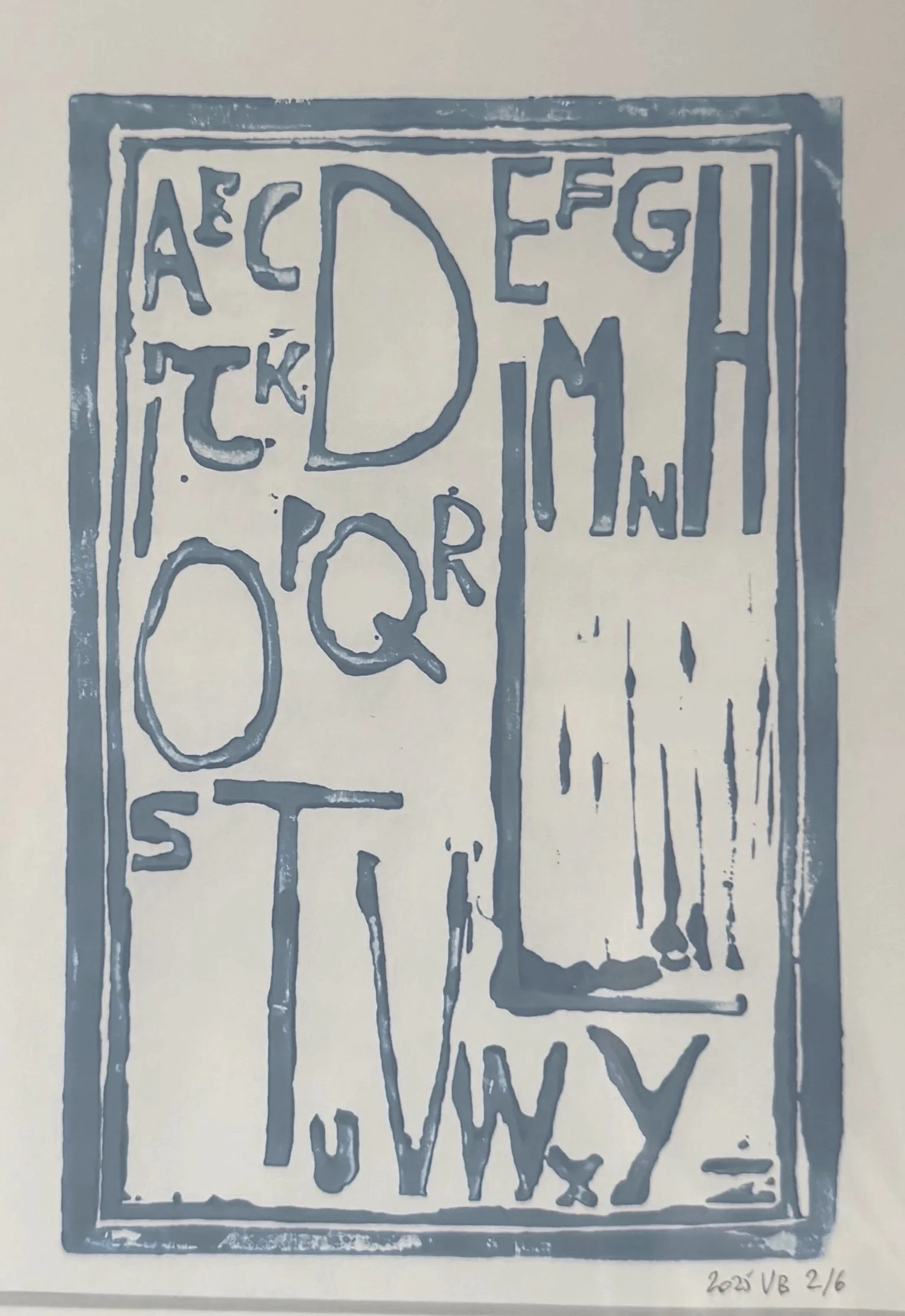 A graphic drawing featuring the alphabet letters arranged in a pattern, with some letters inside shapes, and dripping paint effect at the bottom. There is a signature and date in the lower right corner.