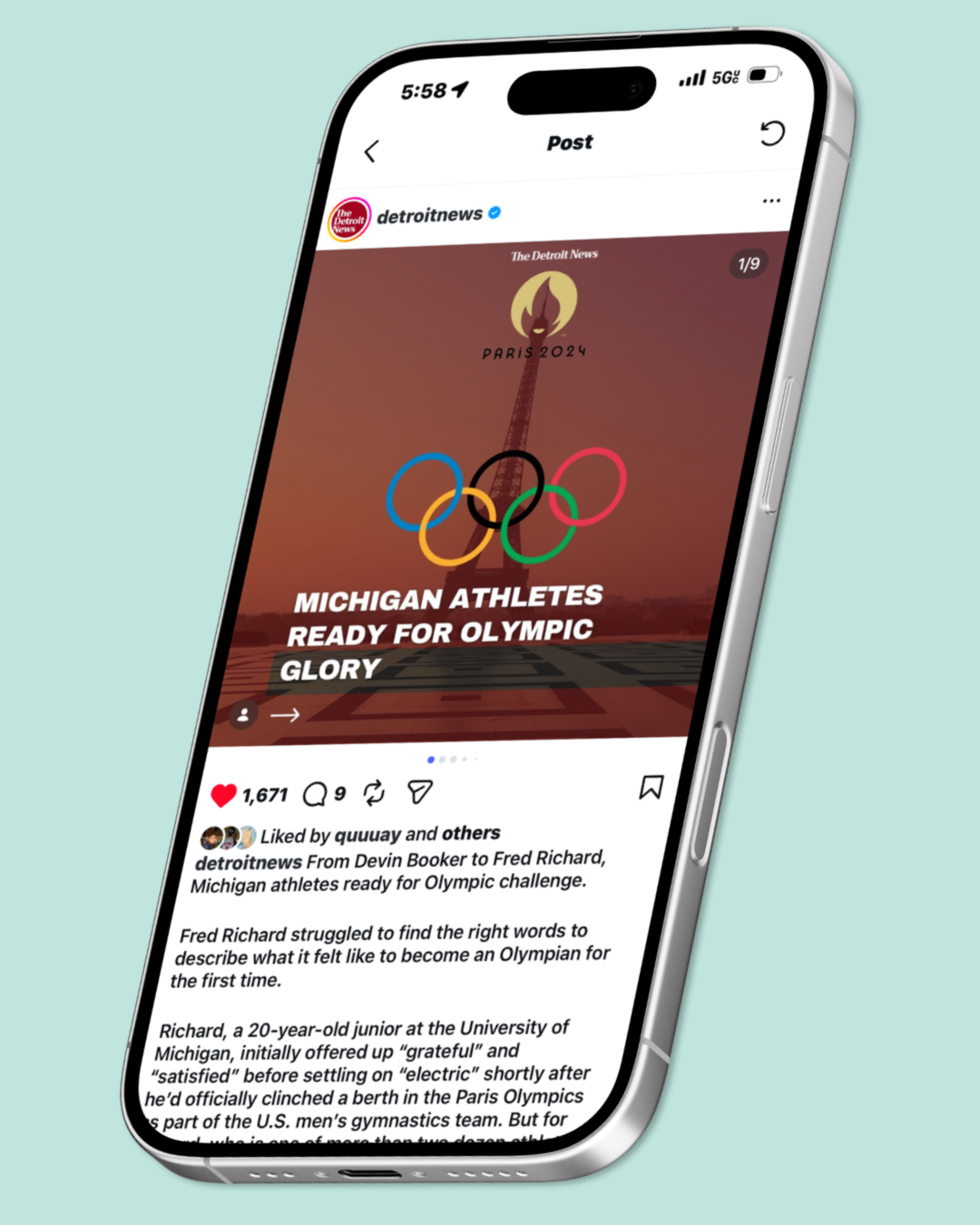 A smartphone displaying a social media post from Detroit News about Michigan athletes preparing for the Olympics, with a Paris 2024 logo and Olympic rings.