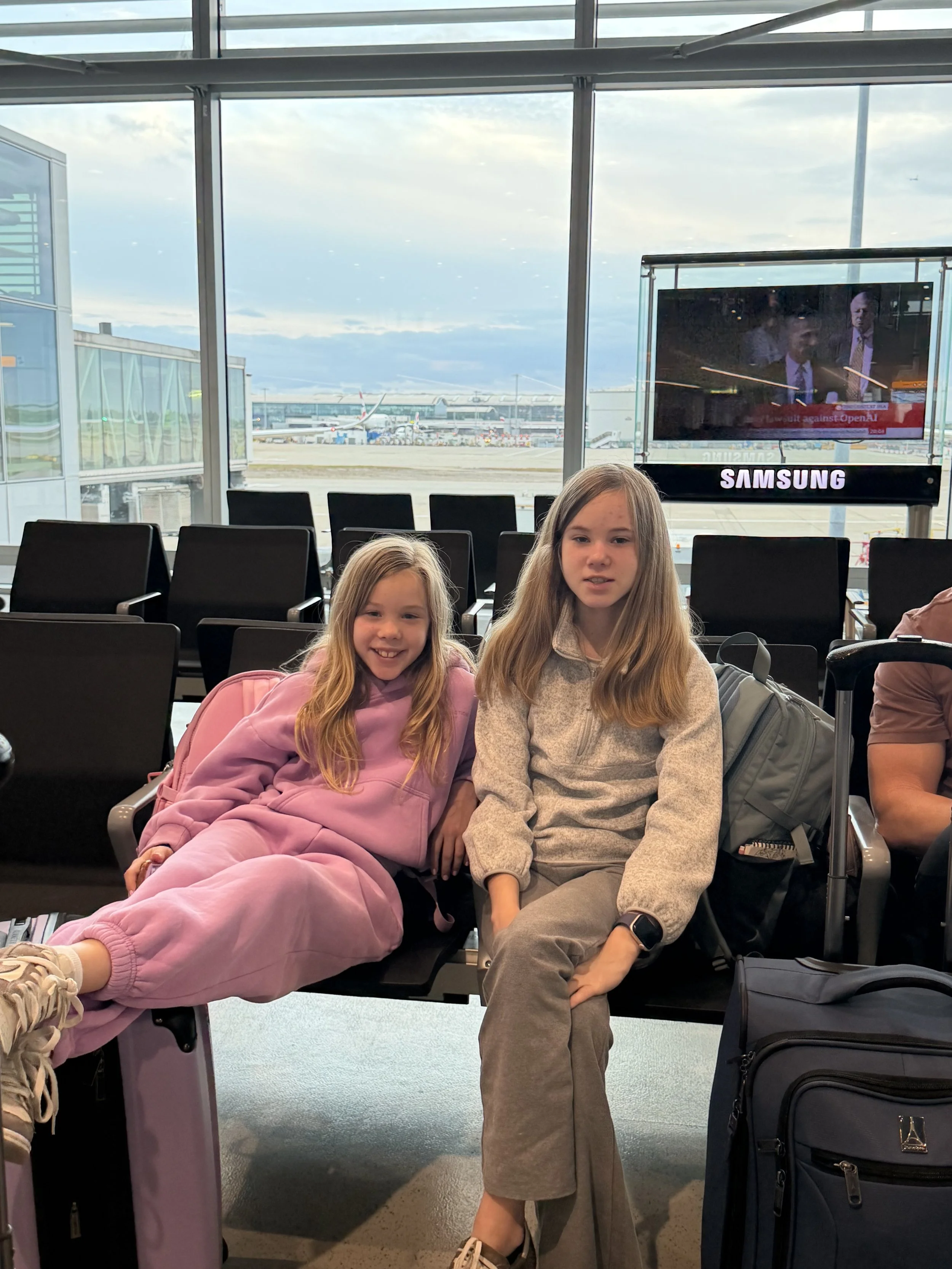 Sisters at the airport in loungewear before a long flight