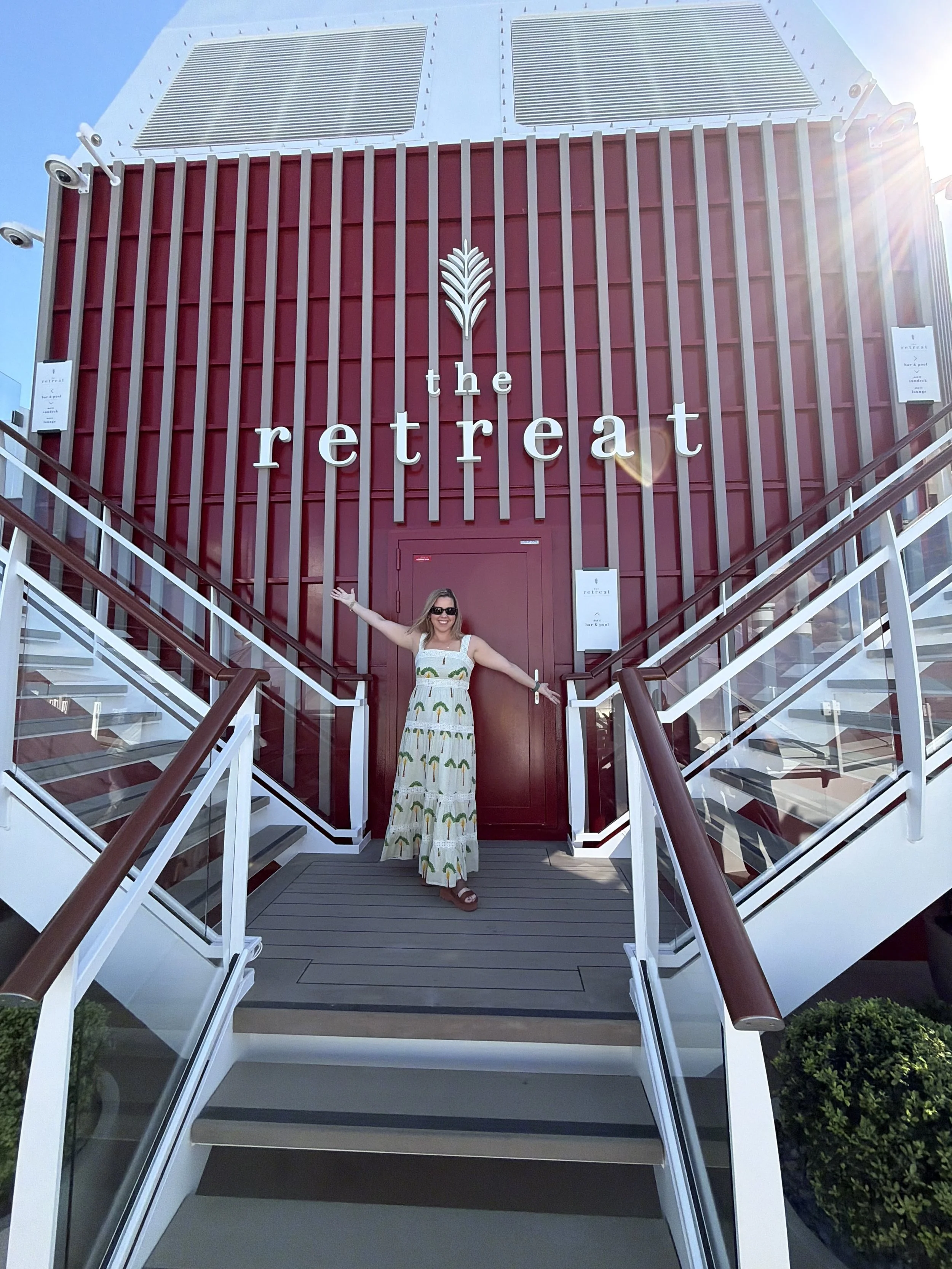 Woman in sundress at the Retreat entrance on the Celebrity XCel staircase