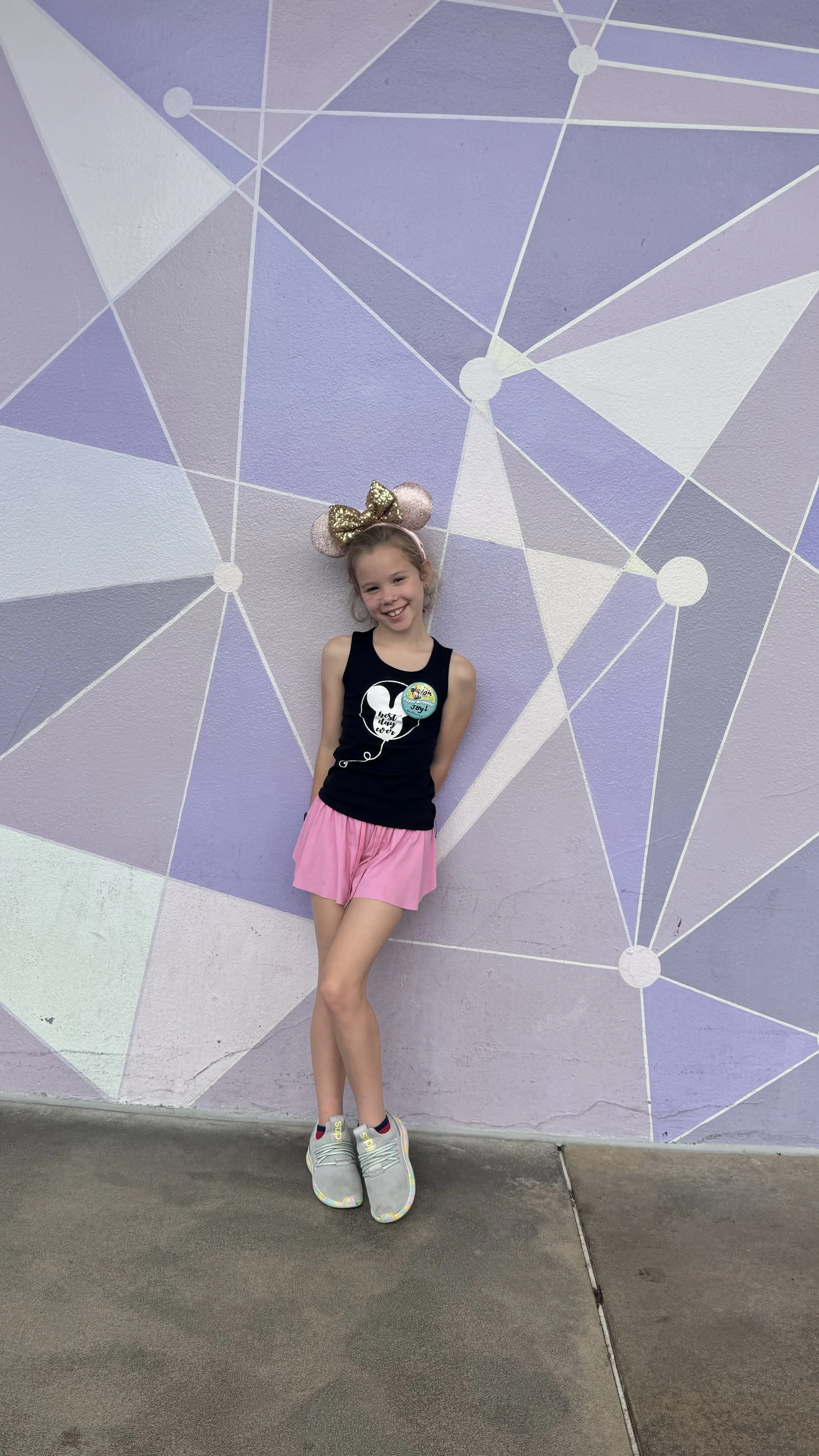 The purple wall at Magic Kingdom makes for a cute backdrop!
