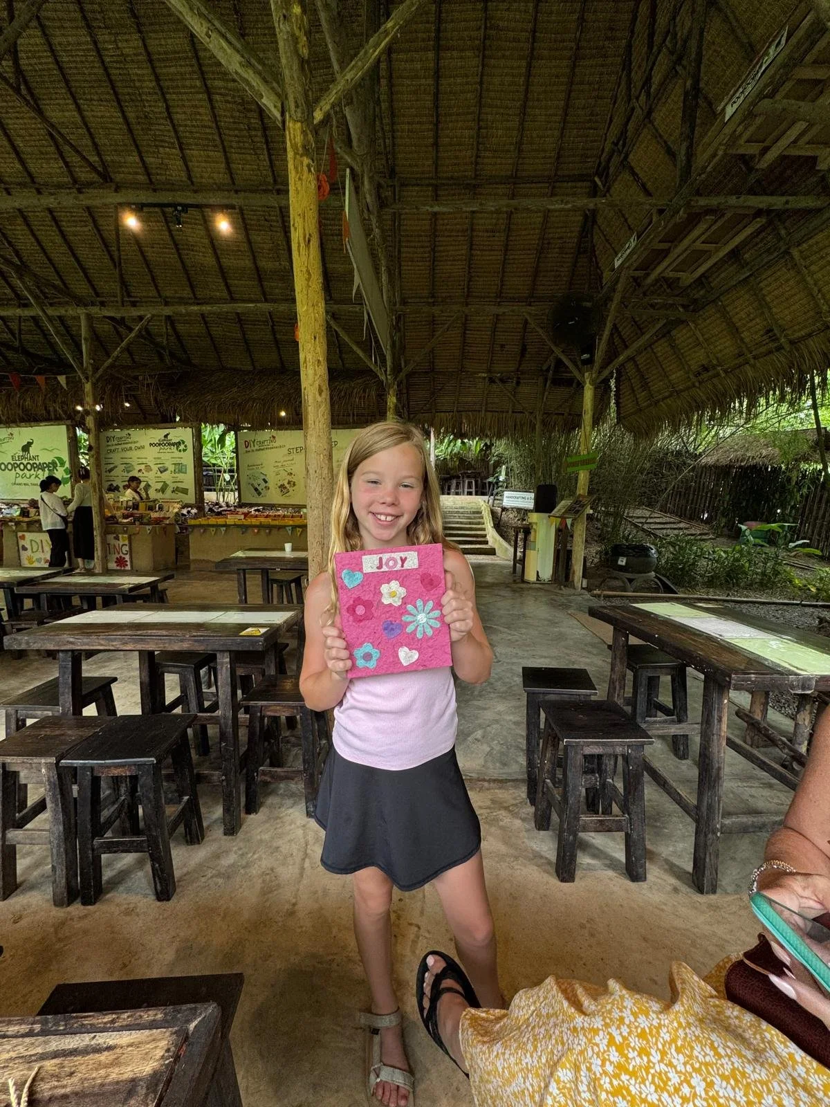 Young girl, Elephant Poo Poo Park in Chiang Mai, Thailand, creating book cover