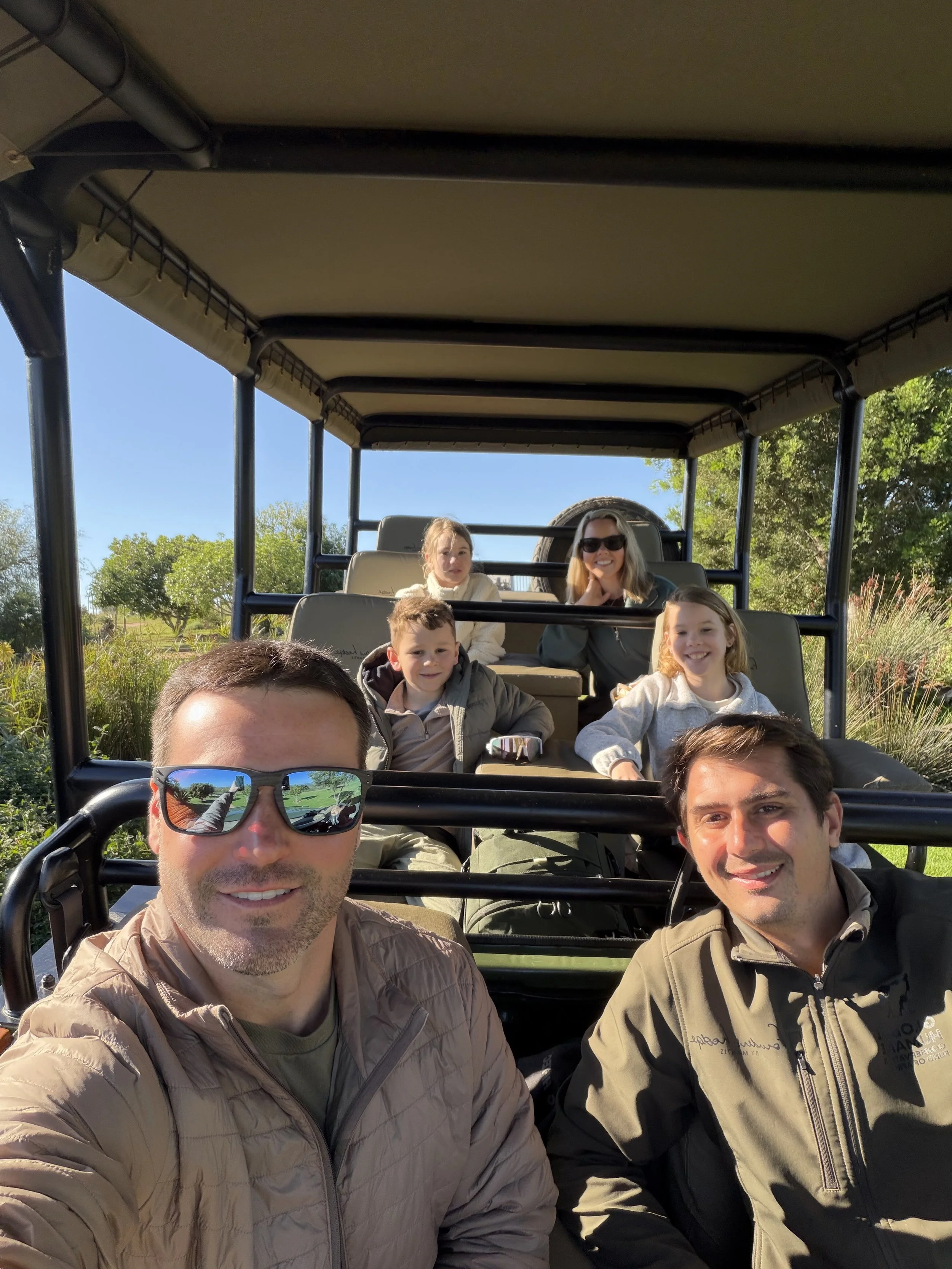 Juvan, our safari game guide with our family of 5 on the safari truck