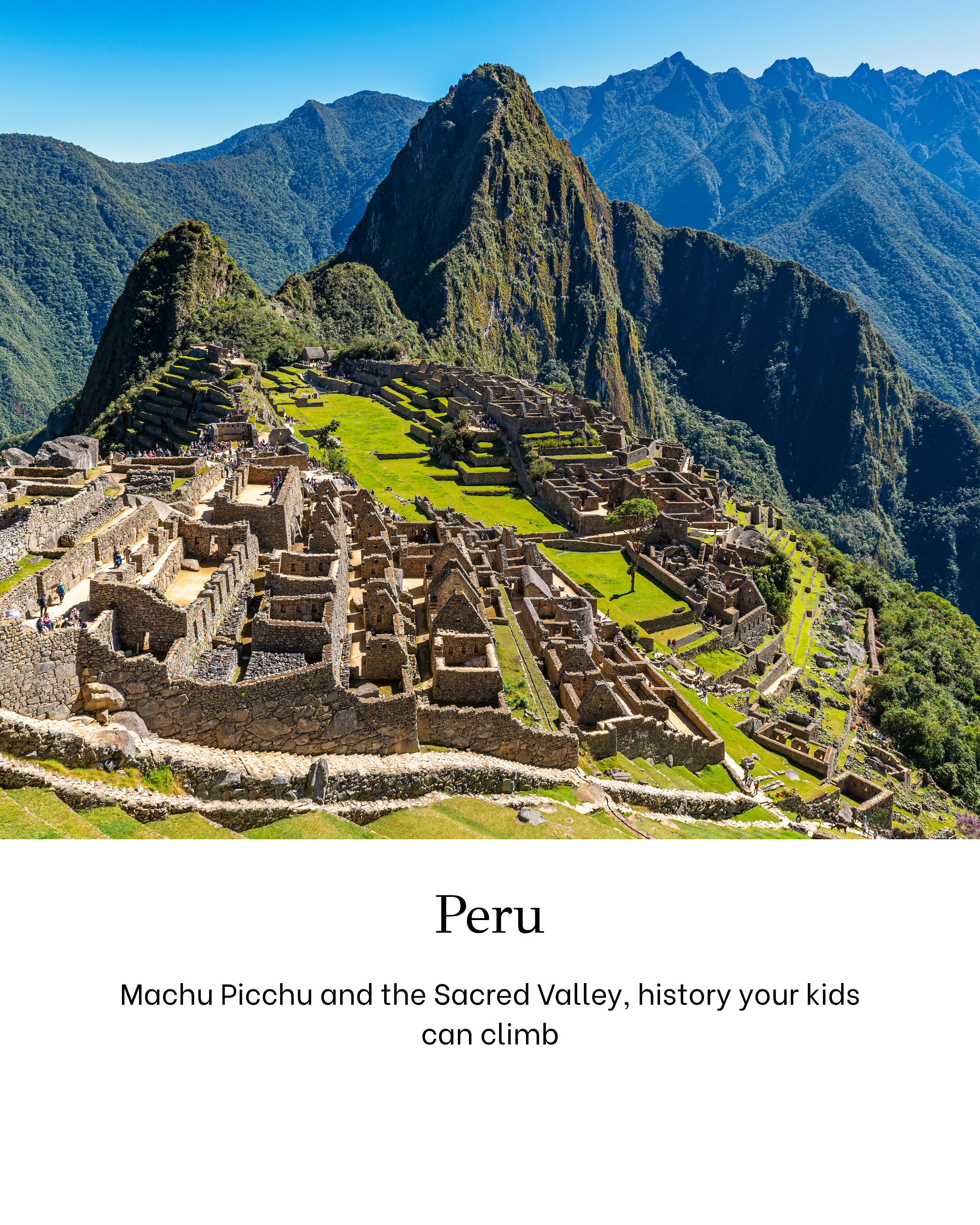 Photograph of Machu Picchu, an ancient Incan city located in Peru, with stone ruins and terraces set against lush green mountains under a clear blue sky.