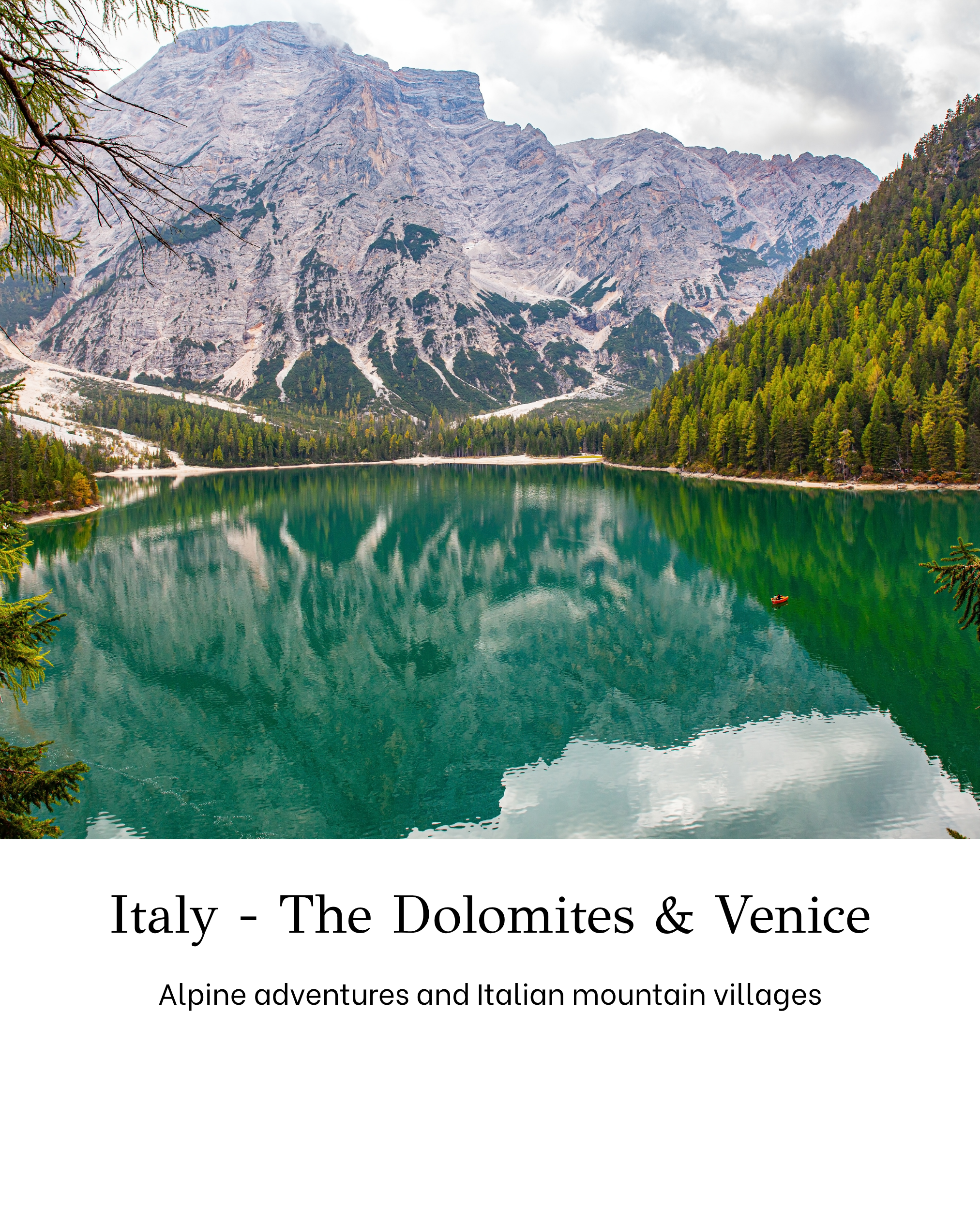 View of a mountain lake surrounded by the Dolomites with dense evergreen forest on the right and a rocky mountain peak in the background.