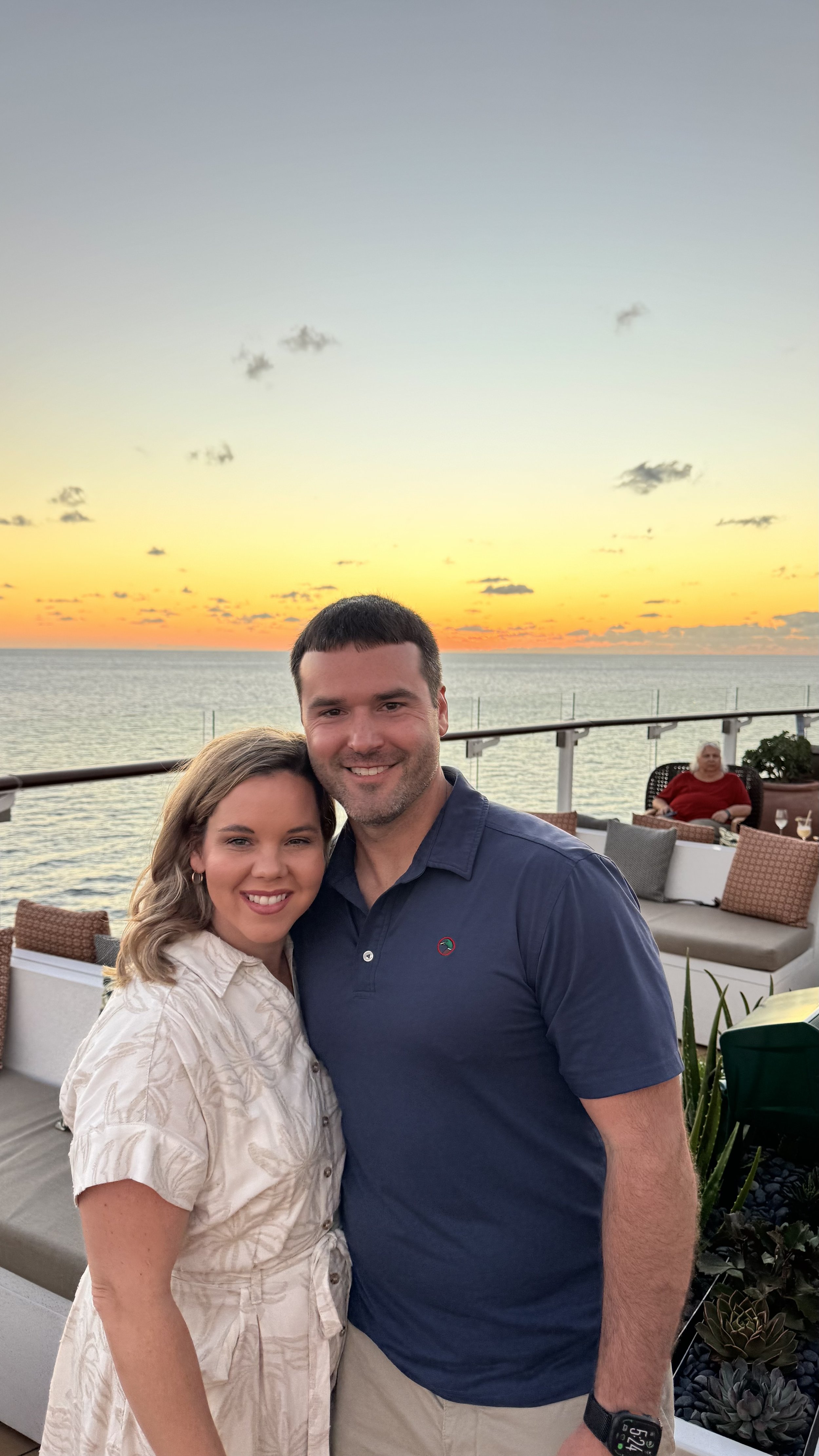 Husband and wife, sunset background on Celebrity XCel sailing near the back of the ship