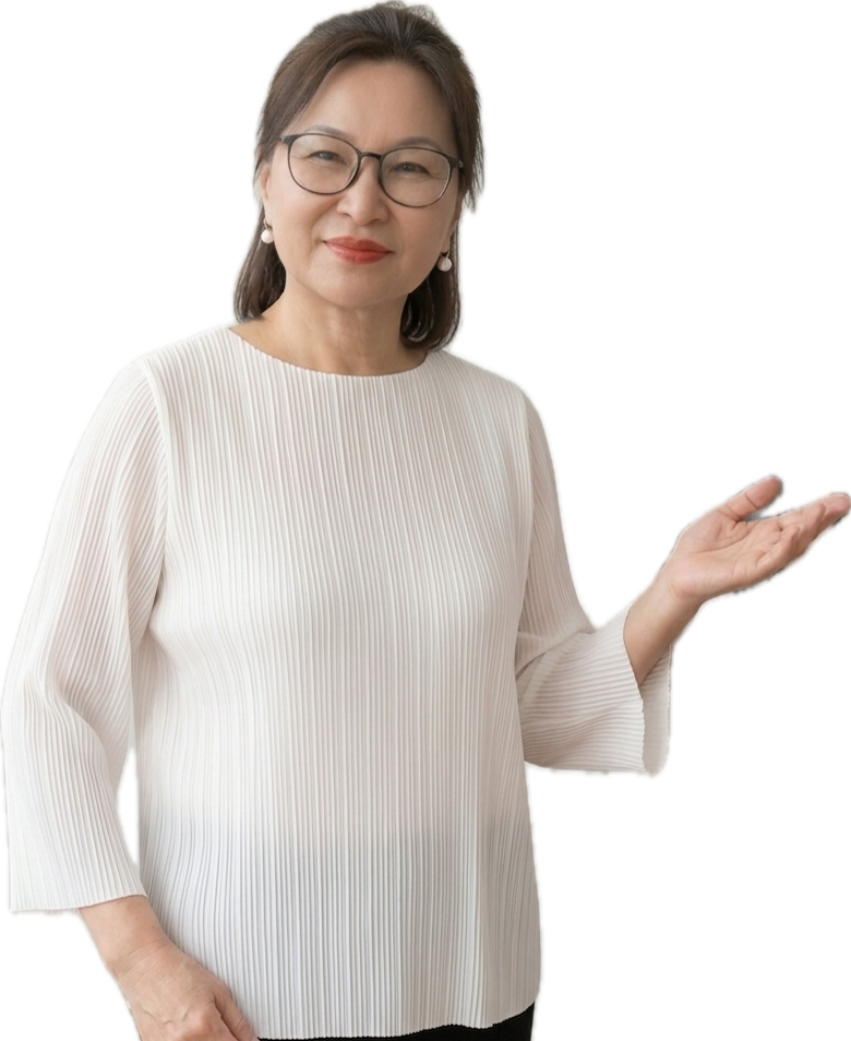 A middle-aged woman with glasses, wearing a white pleated blouse, smiling slightly, holding her left hand up in a casual gesture.