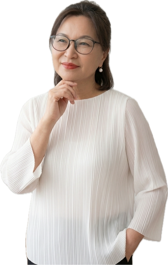 An older woman with glasses and pearl earrings, wearing a white pleated blouse, thoughtfully resting her chin on her hand with a slight smile.