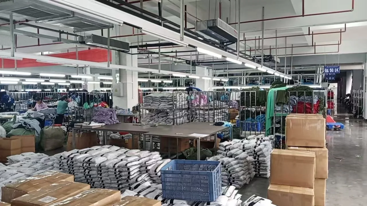Warehouse or factory with stacked bags, boxes, and workers sorting or packing items under bright overhead lights.