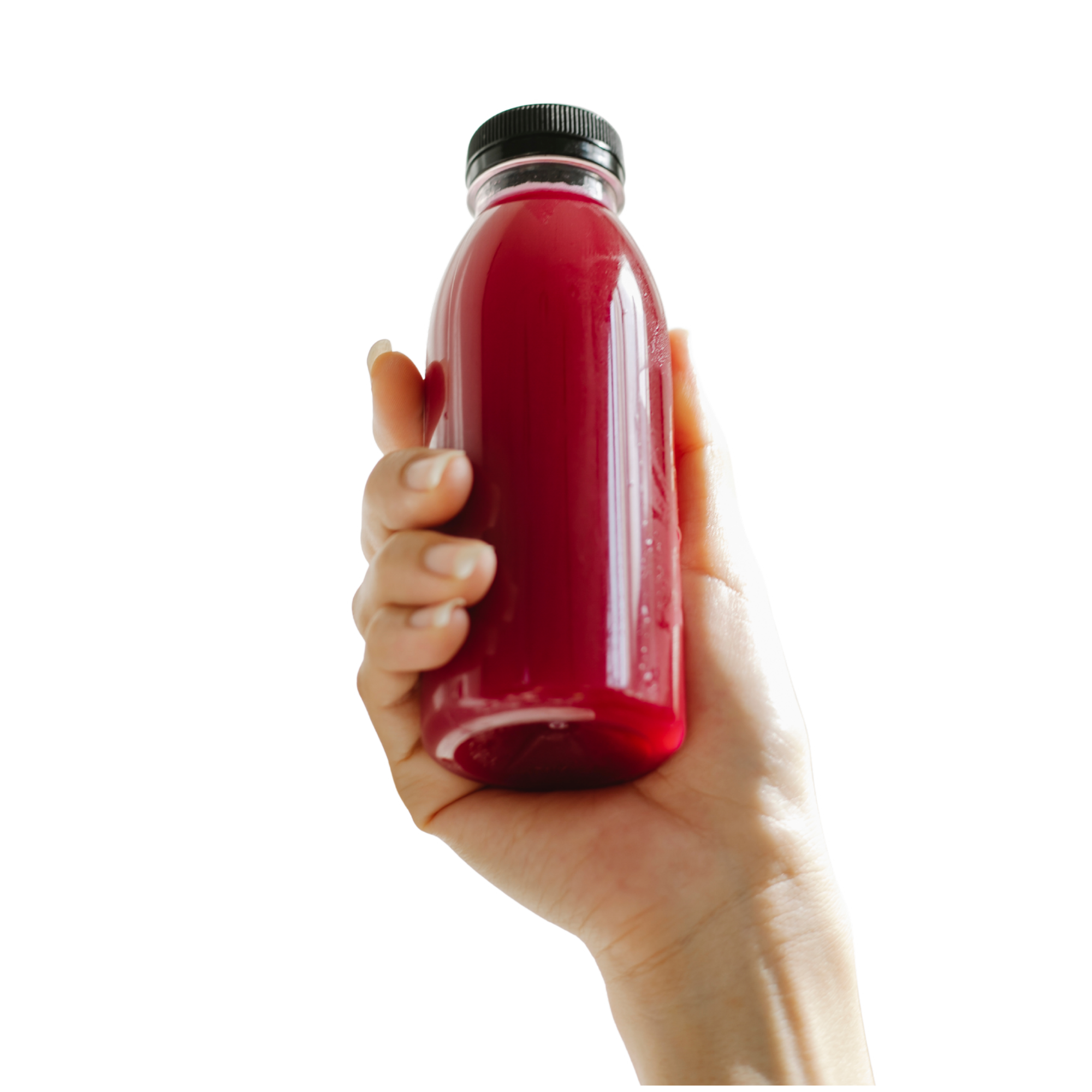 Hand holding a small glass bottle filled with red liquid against a white background.