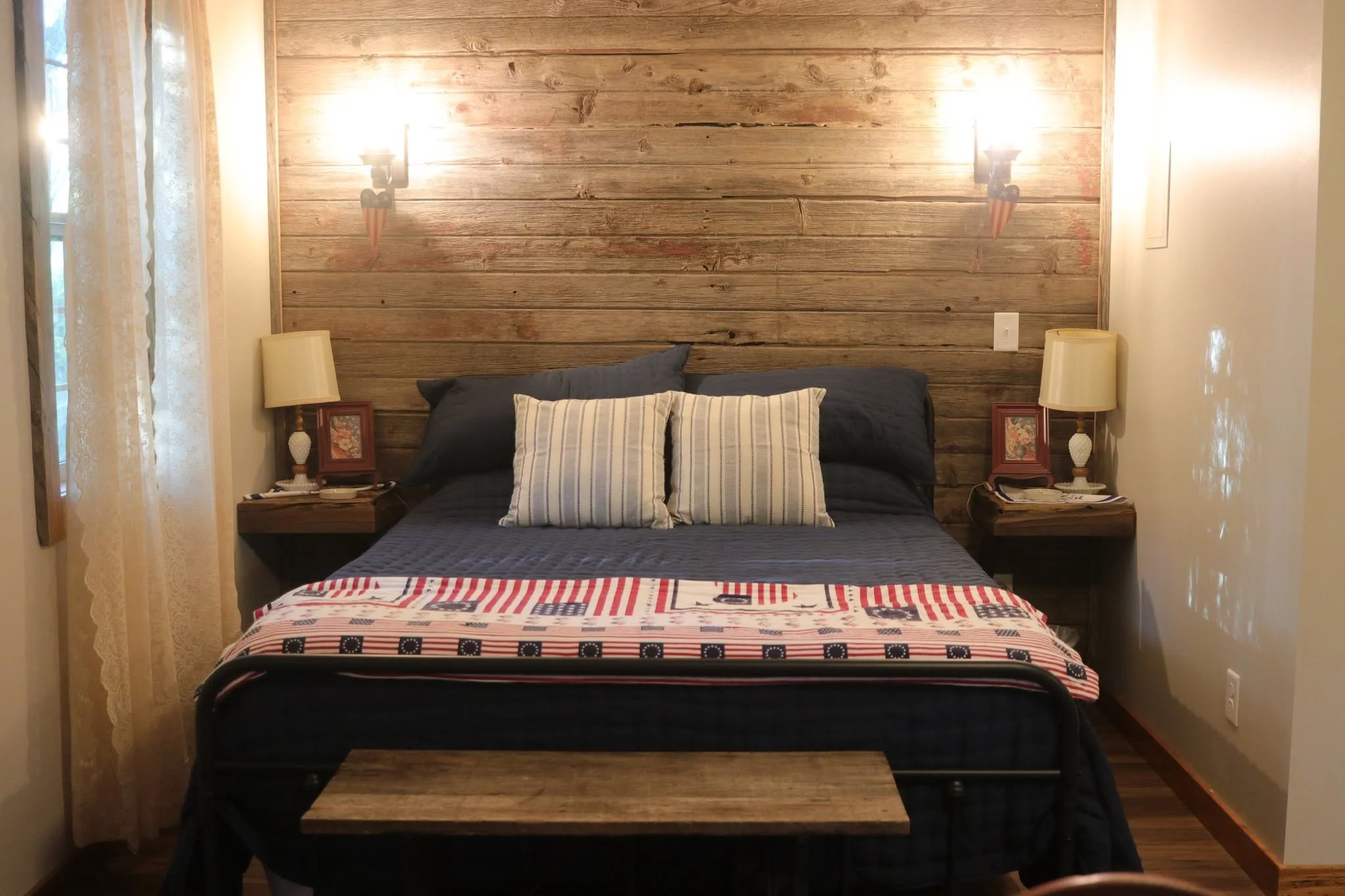 Relax in the cozy bedroom at Old Glory Cabin, a peaceful Kansas cabin retreat perfect for wedding guests, romantic getaways, and restful weekend stays.