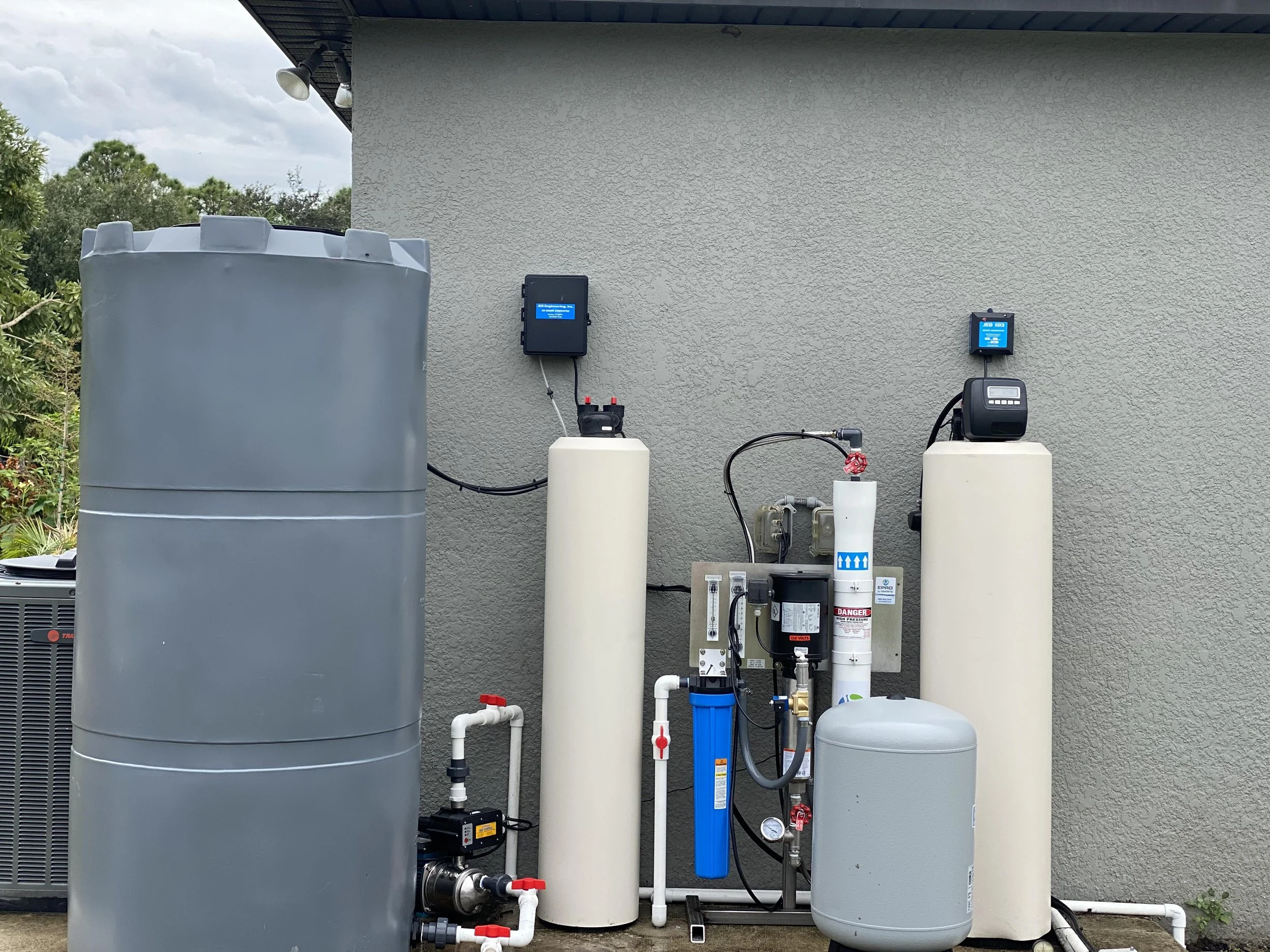 I this picture there is a Whole House Reverse osmosis set up. To the left is the grey fresh water holding tank. to the right is the pre and post treatment tanks with the RO in-between them.