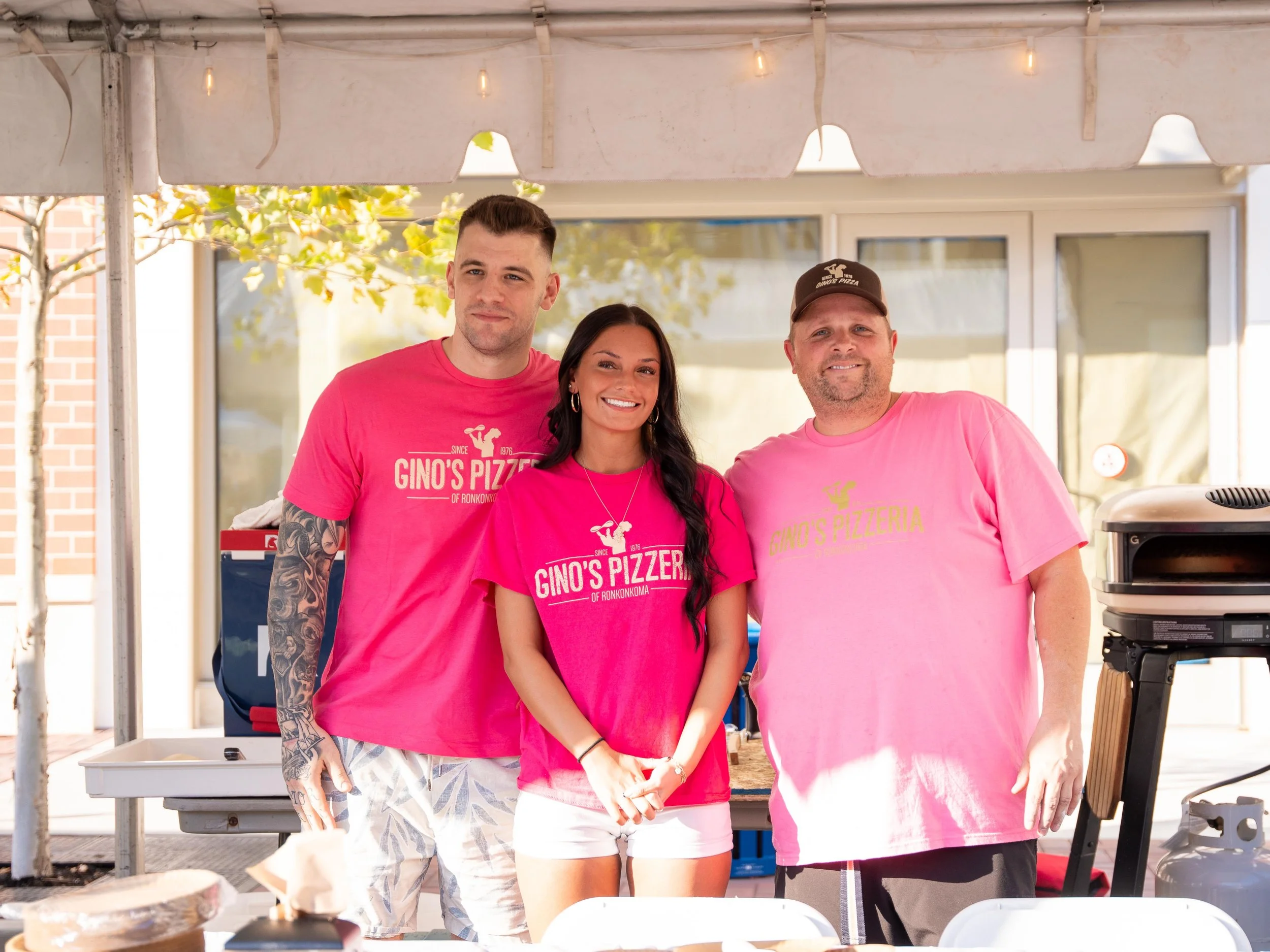 Gino's Pizza Vendor Staff In Pink Shirts