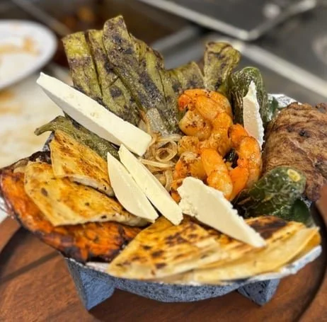 Assorted grilled vegetables with cheese slices in a bowl