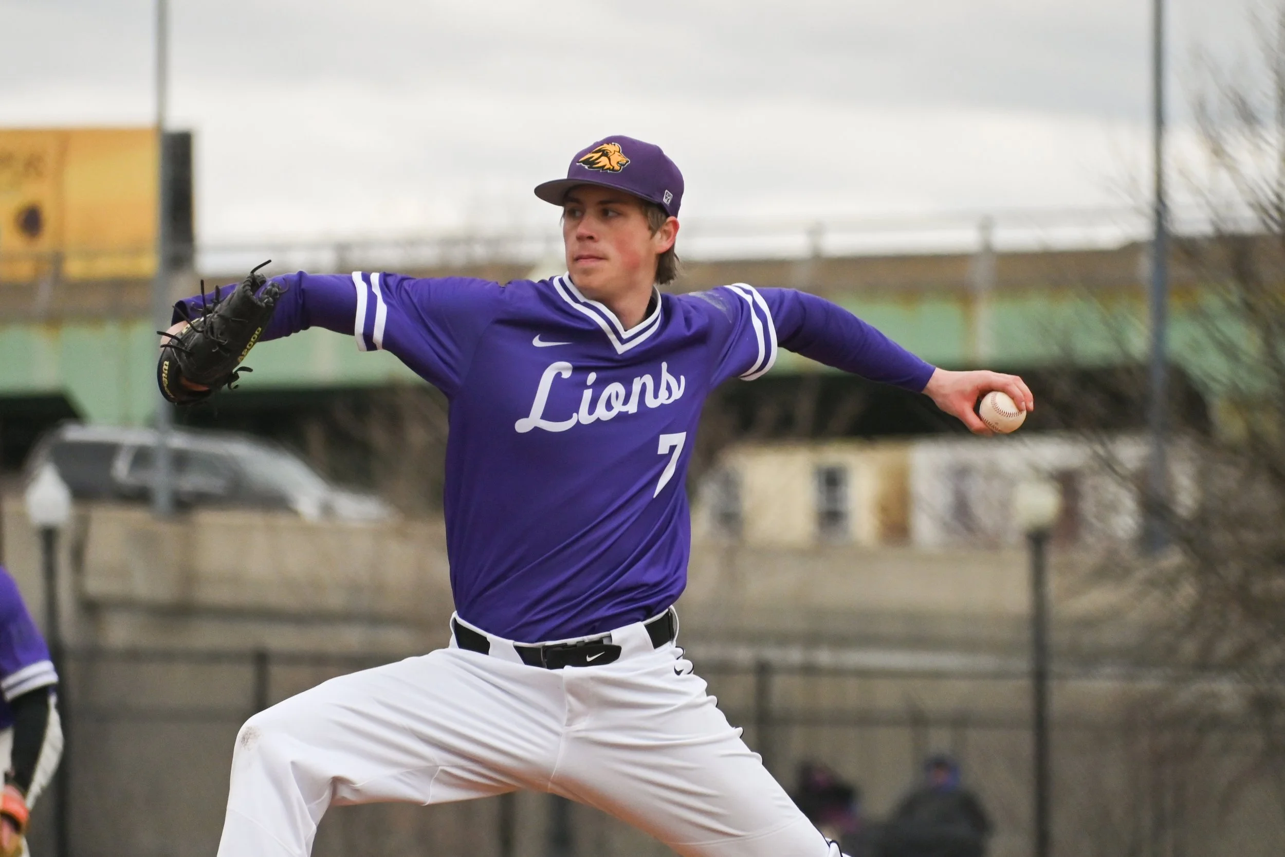 Russell Silverman pitching in a Lions baseball uniform