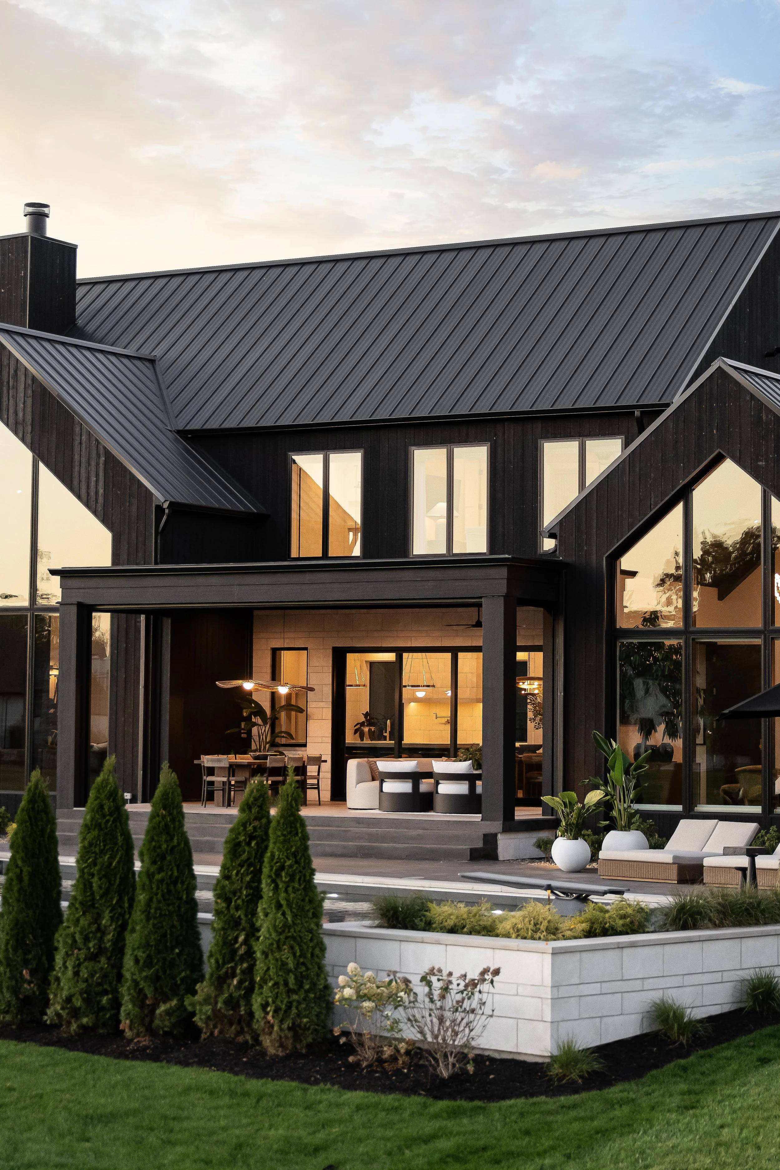 Layered rooflines, contrasting materials, and expansive windows define this modern organic exterior.