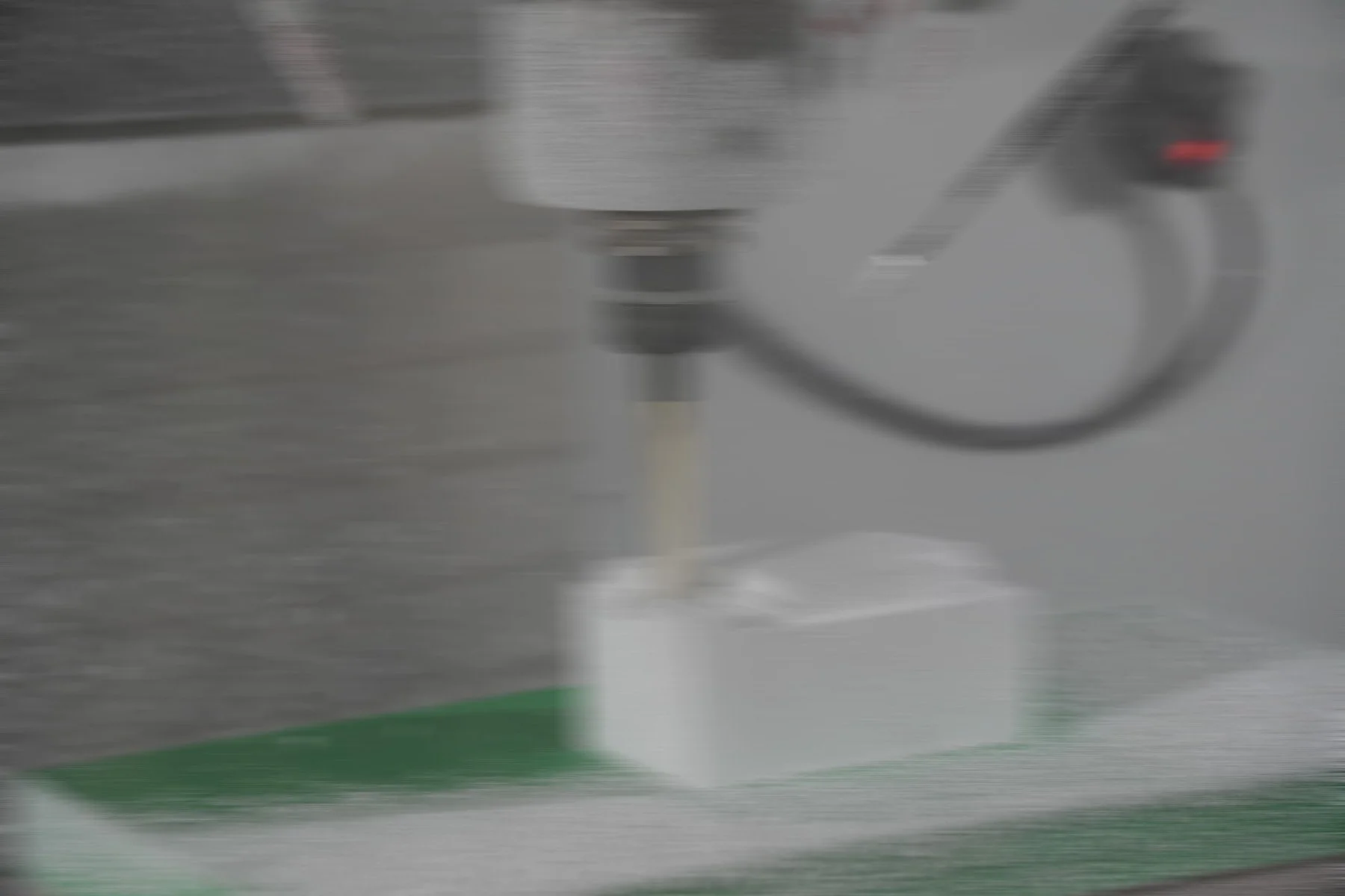 Close-up of a tool on a metallic work surface, with a black wire connected to it. manufacturing company Winston-Salem history