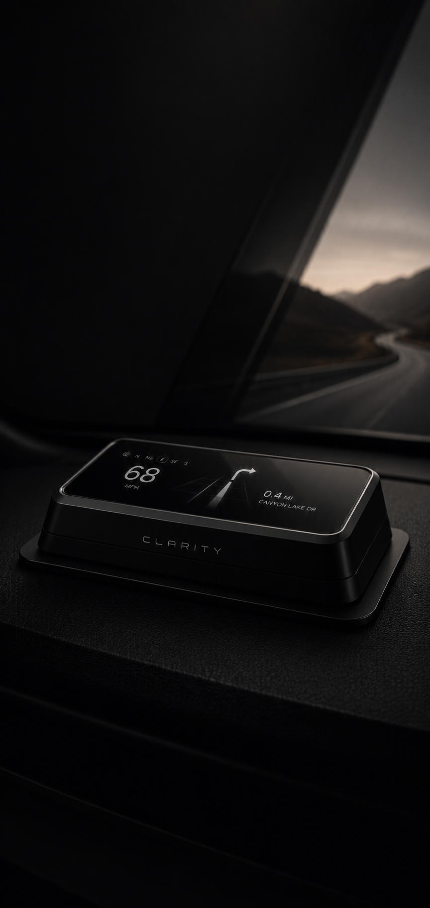 A digital car navigation device displaying the current speed of 68 MPH, a right turn on Canyon Lake Drive, and a route map in a dark car interior with a mountain landscape visible through the windshield.